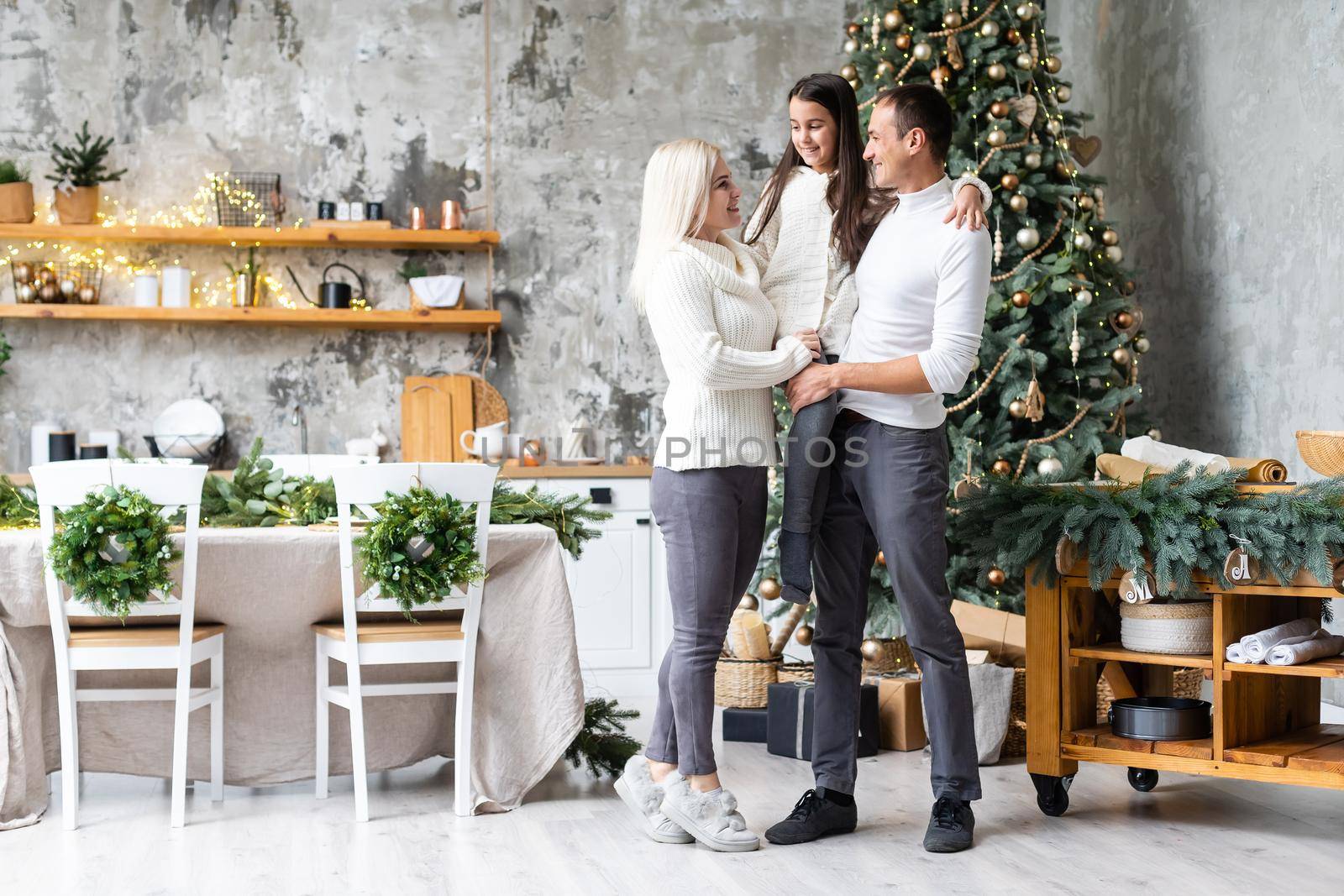 family, christmas, x-mas, winter, happiness and people concept - smiling family Preparing to celebrate Christmas