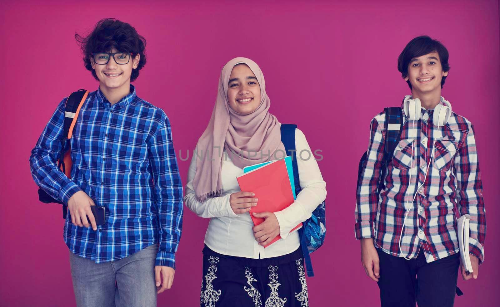 Arabic teenagers group, students team walking forward in future and back to school concept pink background