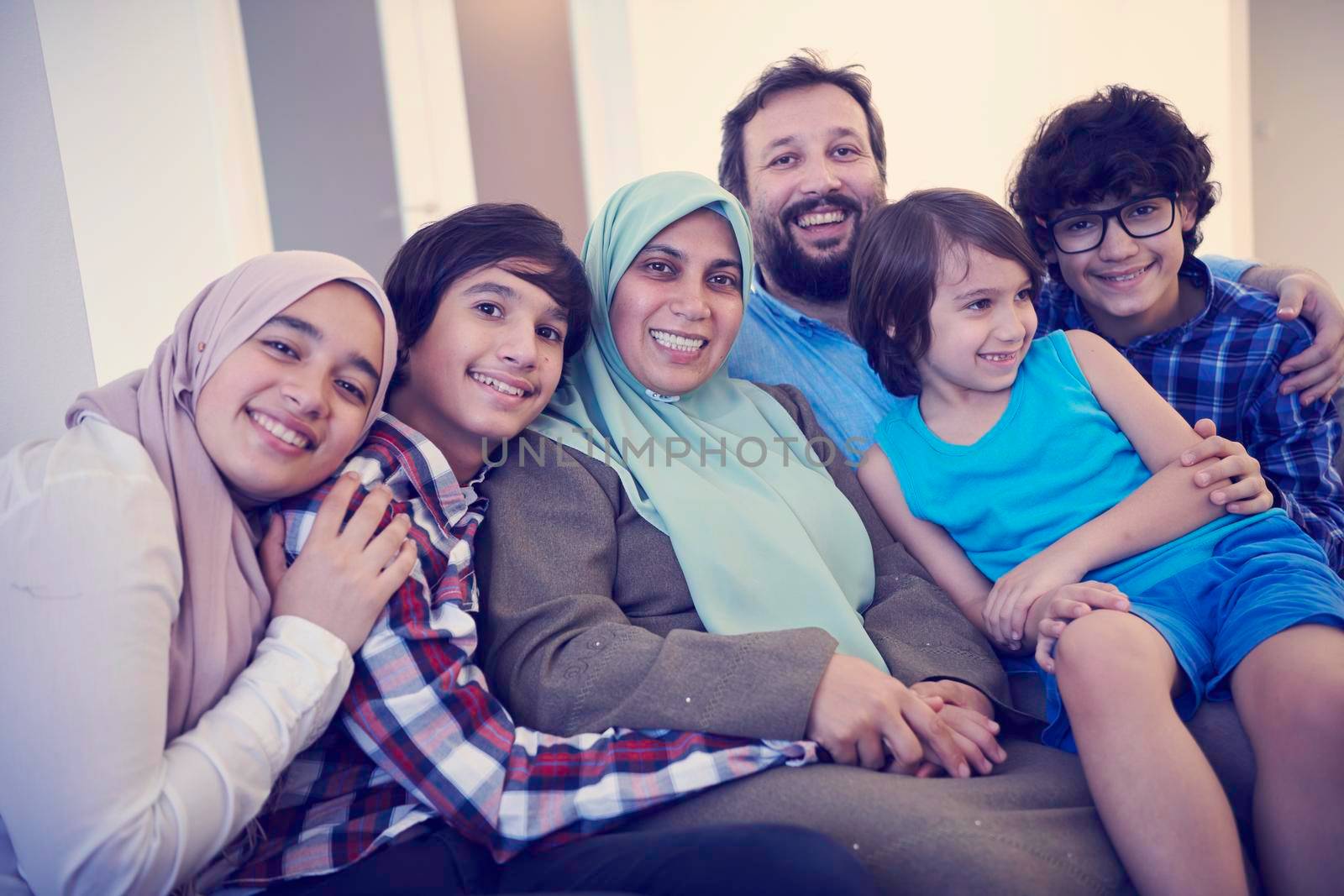 muslim family portrait with arab  teenage kids at modern home interior
