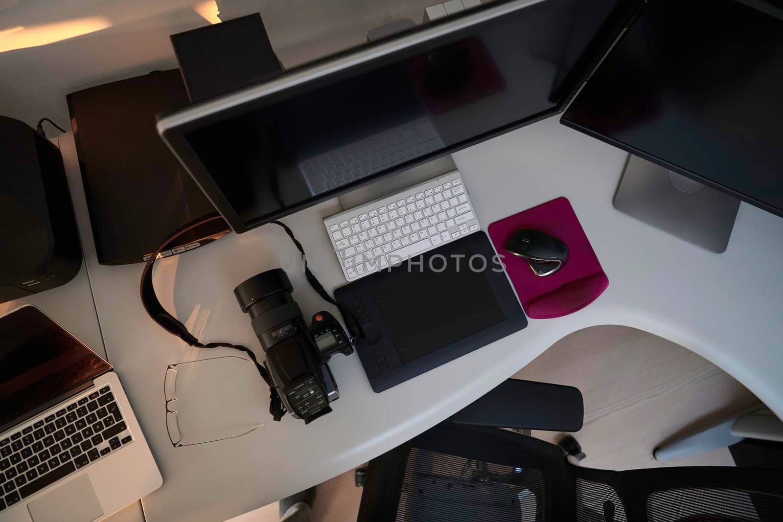 home office photographer workplace with workstation computer  and dual screen monitor modern laptop and medium format dslr camera