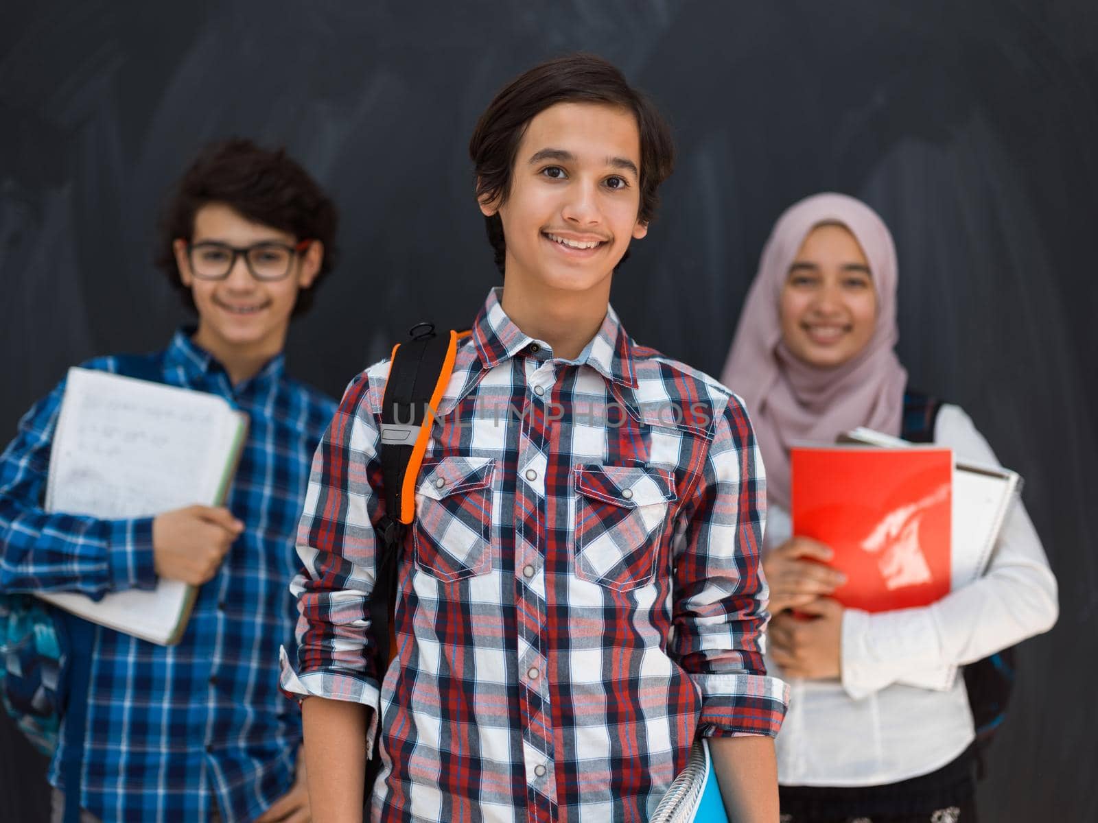 Arabic teenagers team, students group working together on laptop and tablet computer online classroom education concept. Selective focus. High quality photo