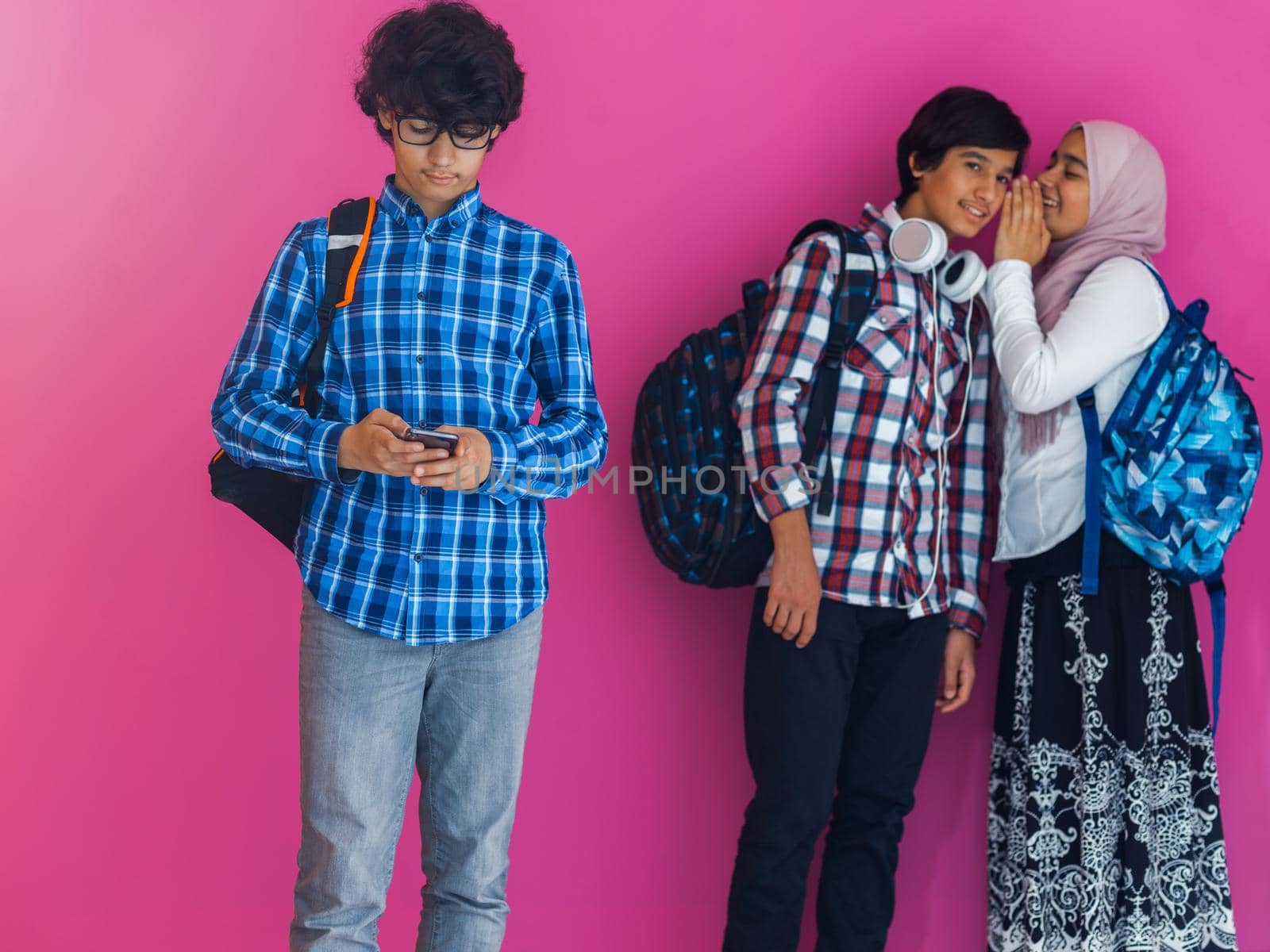 A group of Arab teenagers, a student team walking forward into the future and back to school the concept of a pink background. The concept of successful education for young people. Selective focus. High quality photo