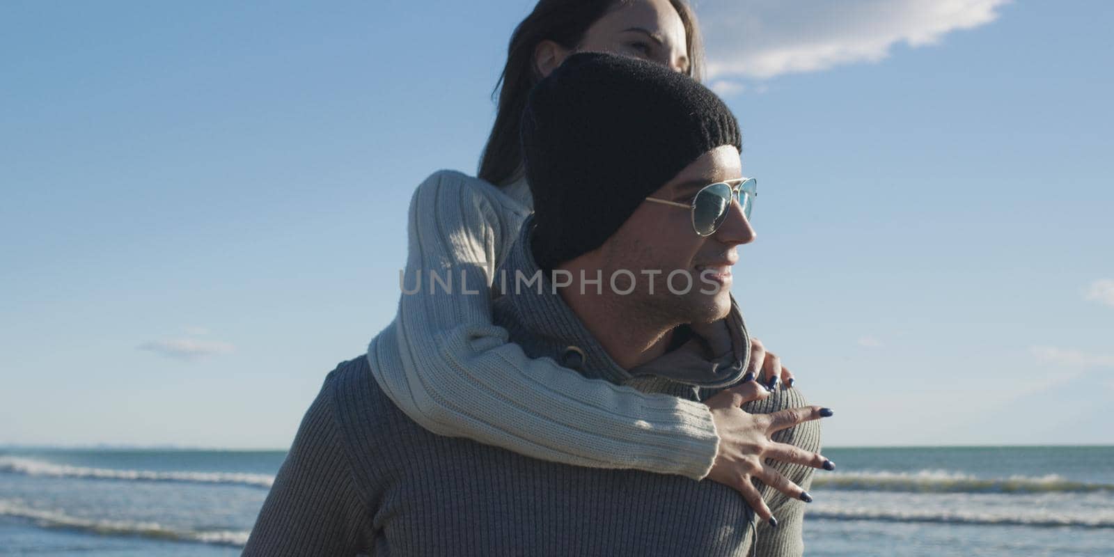 couple having fun at beach during autumn by dotshock