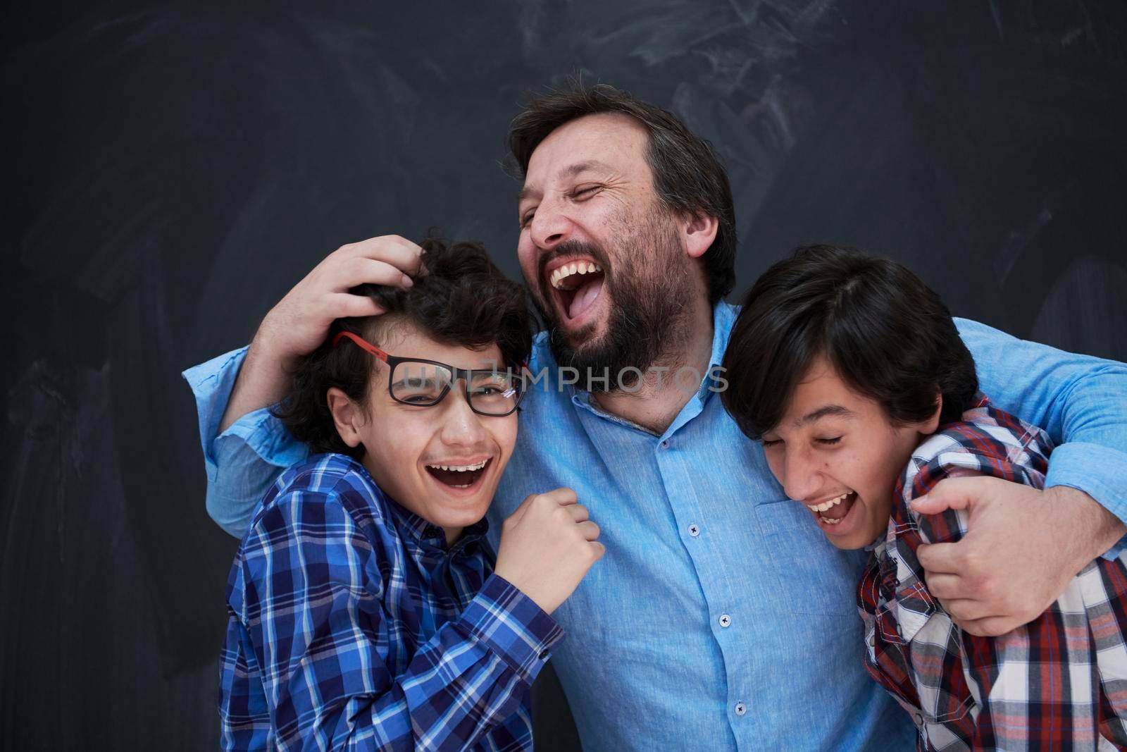happy father hugging sons by dotshock