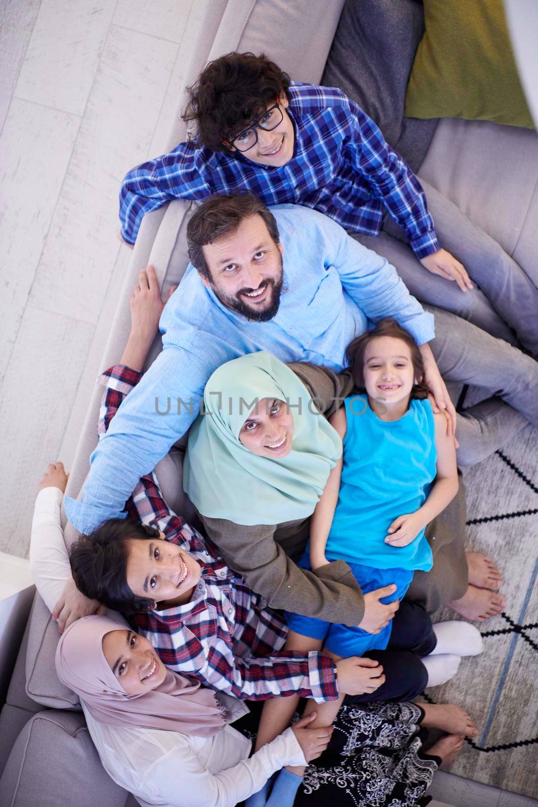 muslim family portrait with arab  teenage kids at modern home interior top view
