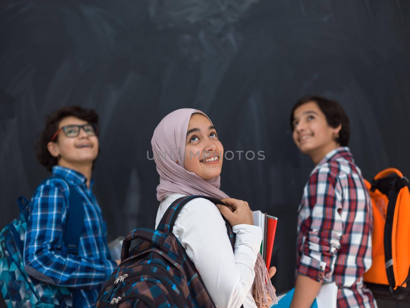 Arabic teenagers team, students group working together on laptop and tablet computer online classroom education concept. Selective focus  by dotshock