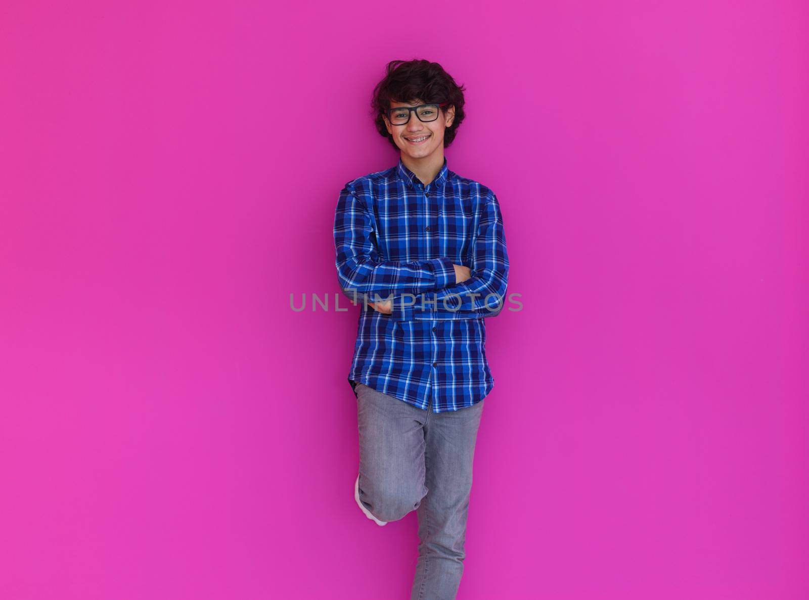 portrait  of smart looking arab teenager  against pink background by dotshock