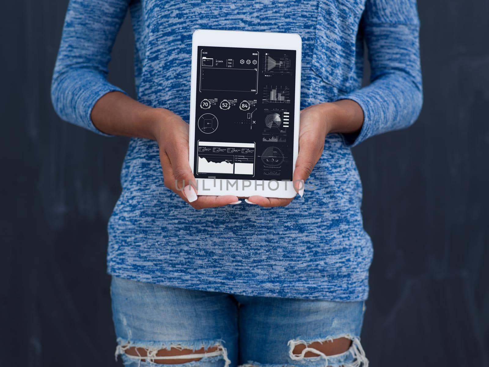 Young Happy African American Woman Using Digital Tablet  Isolated on a gray background