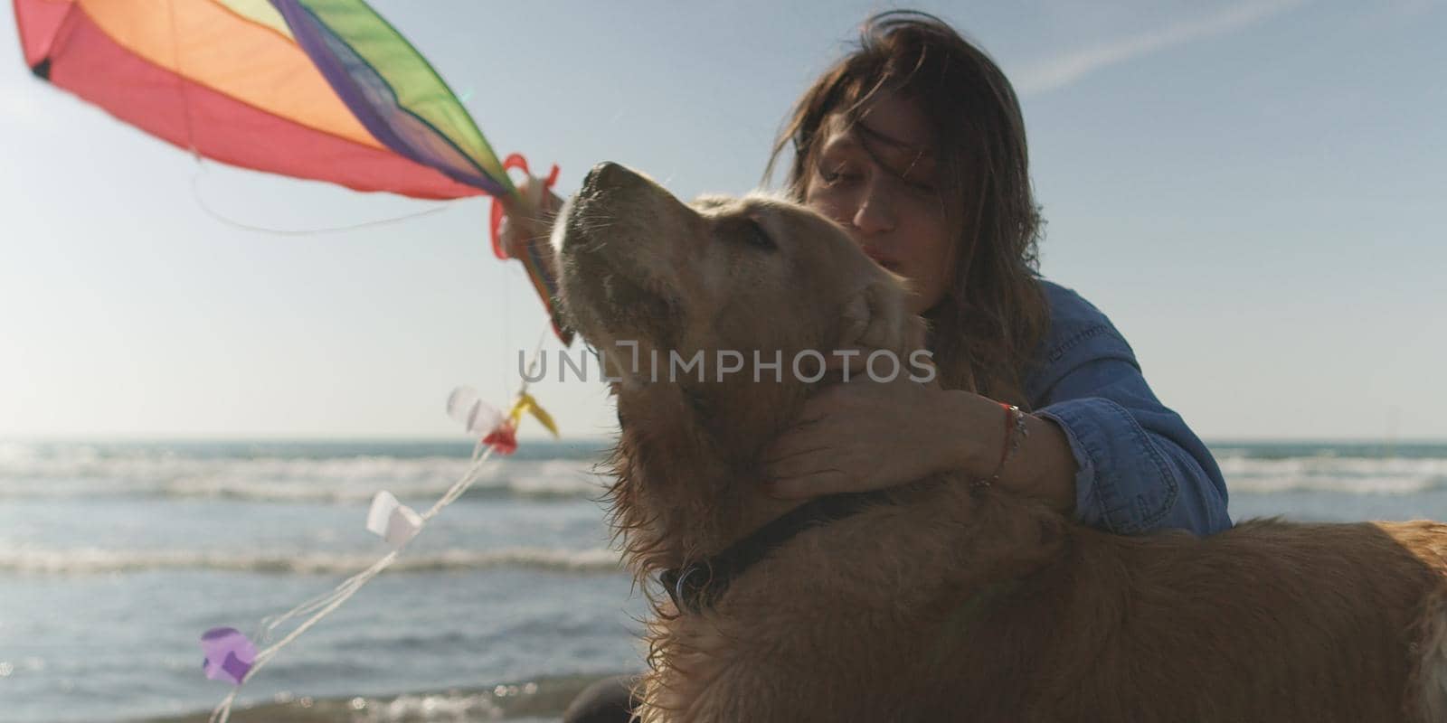Woman holding kite at beach on autumn day by dotshock