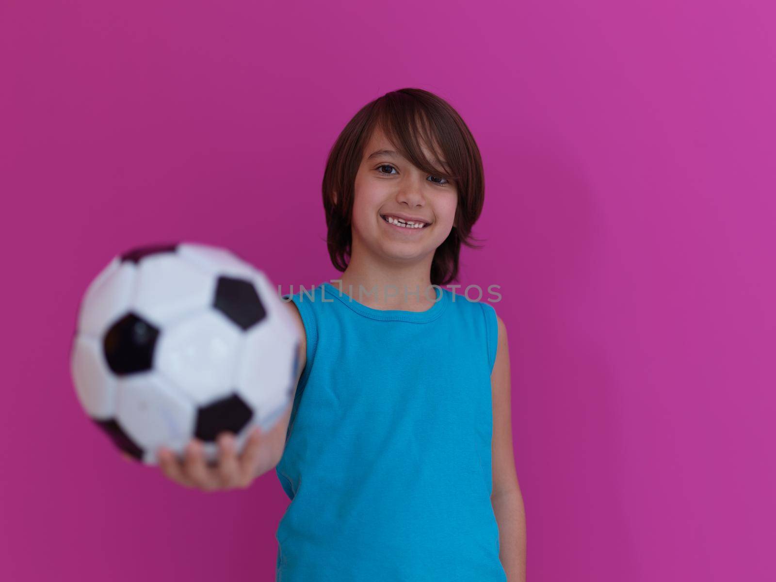 Arabic boy with soccer ball against  pink background by dotshock