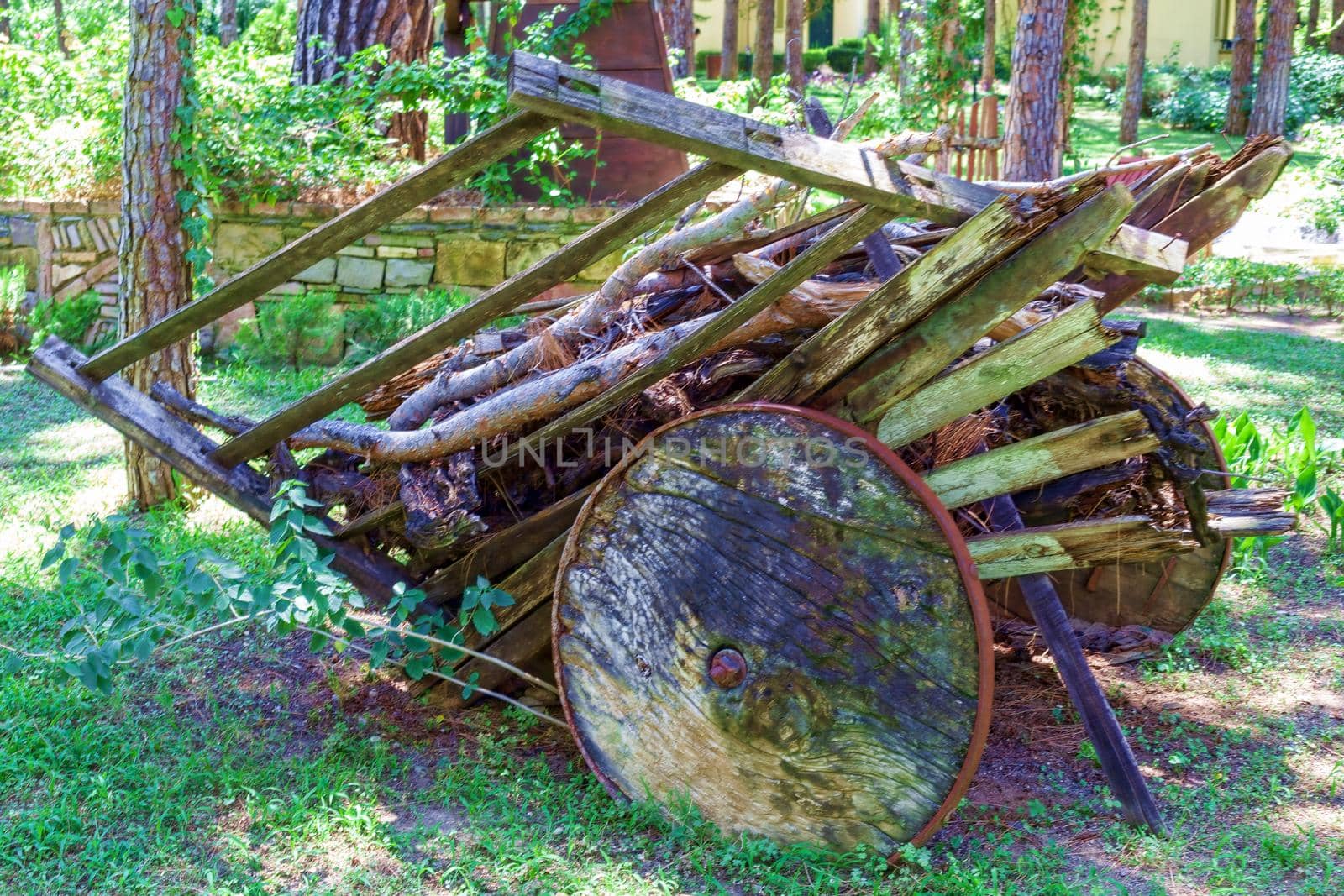 An old, sprawling wooden cart with large wooden wheels. Turkey Kemer.