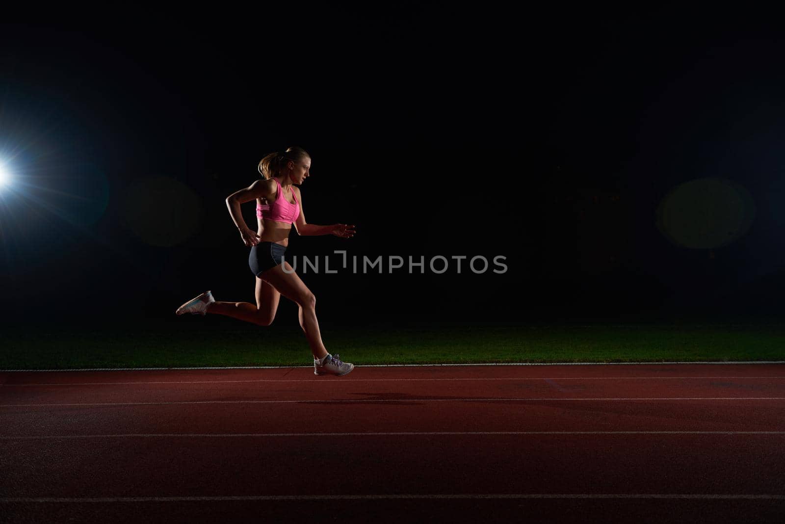 Athletic woman running onrace  track