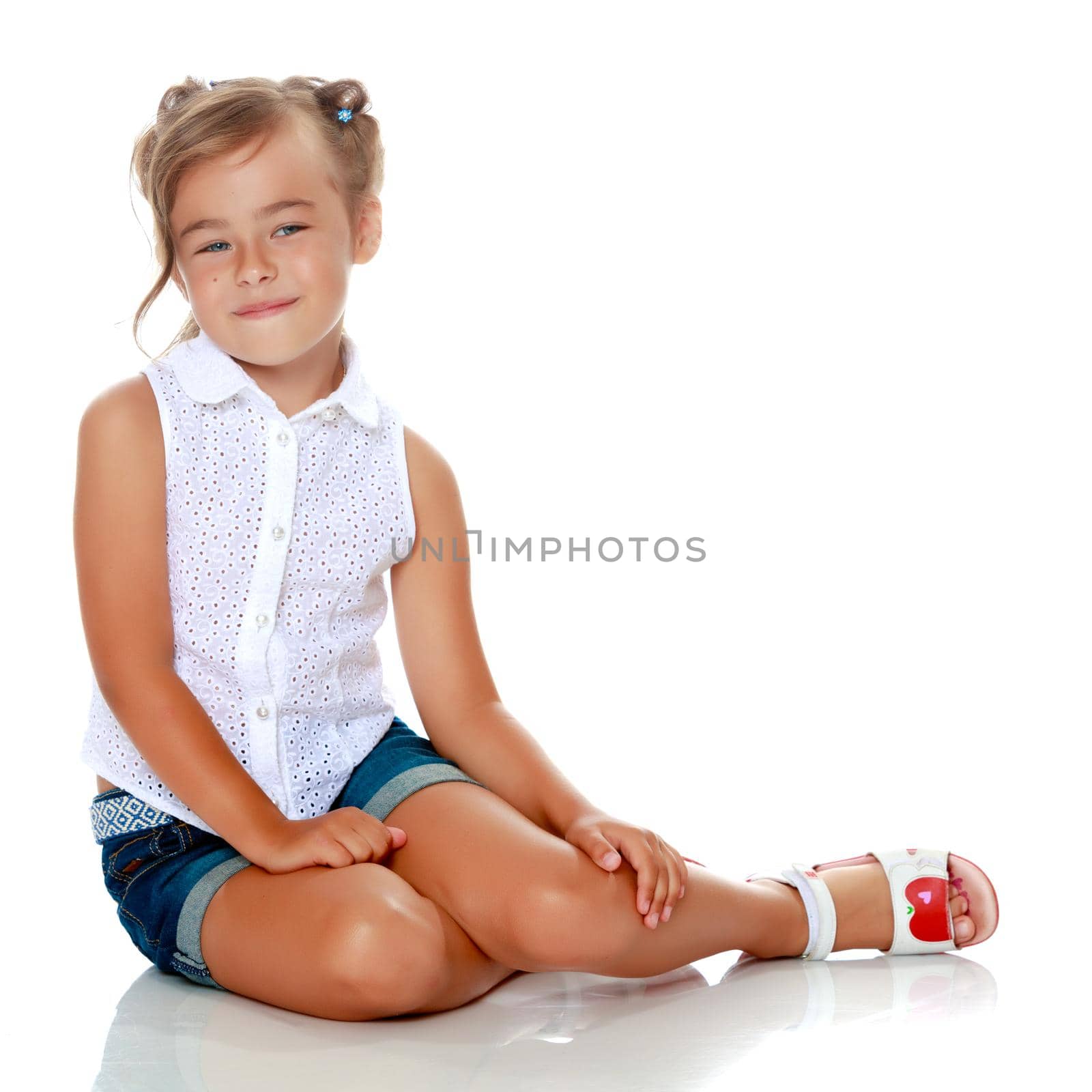 Little girl is sitting on the floor. by kolesnikov_studio