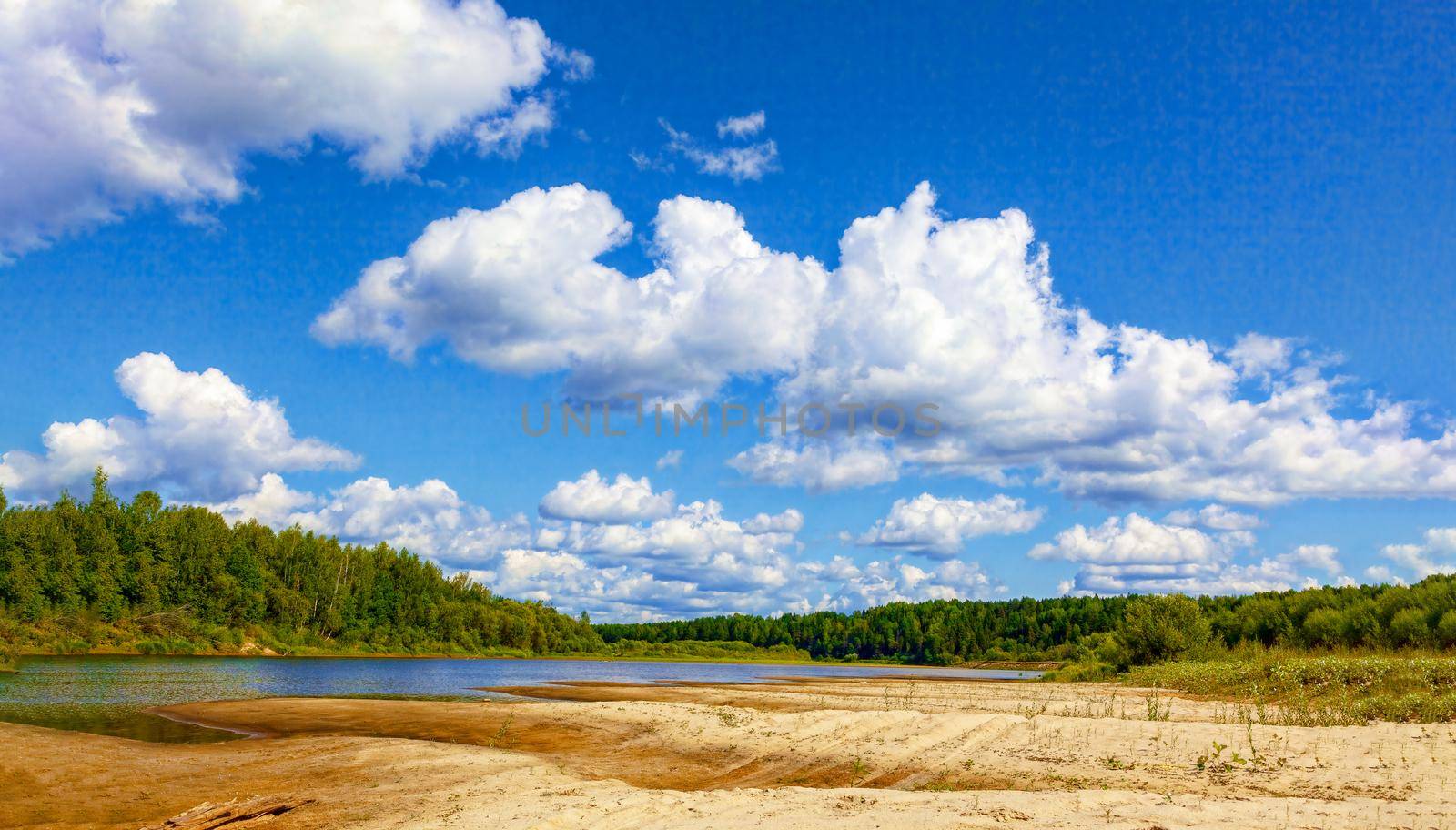 Wild sandy beach near the river on a fine summer day. Only blue sky, sand and a quiet river. Russia, Kostroma region, Kozionikha village. The concept of tourism, native land.