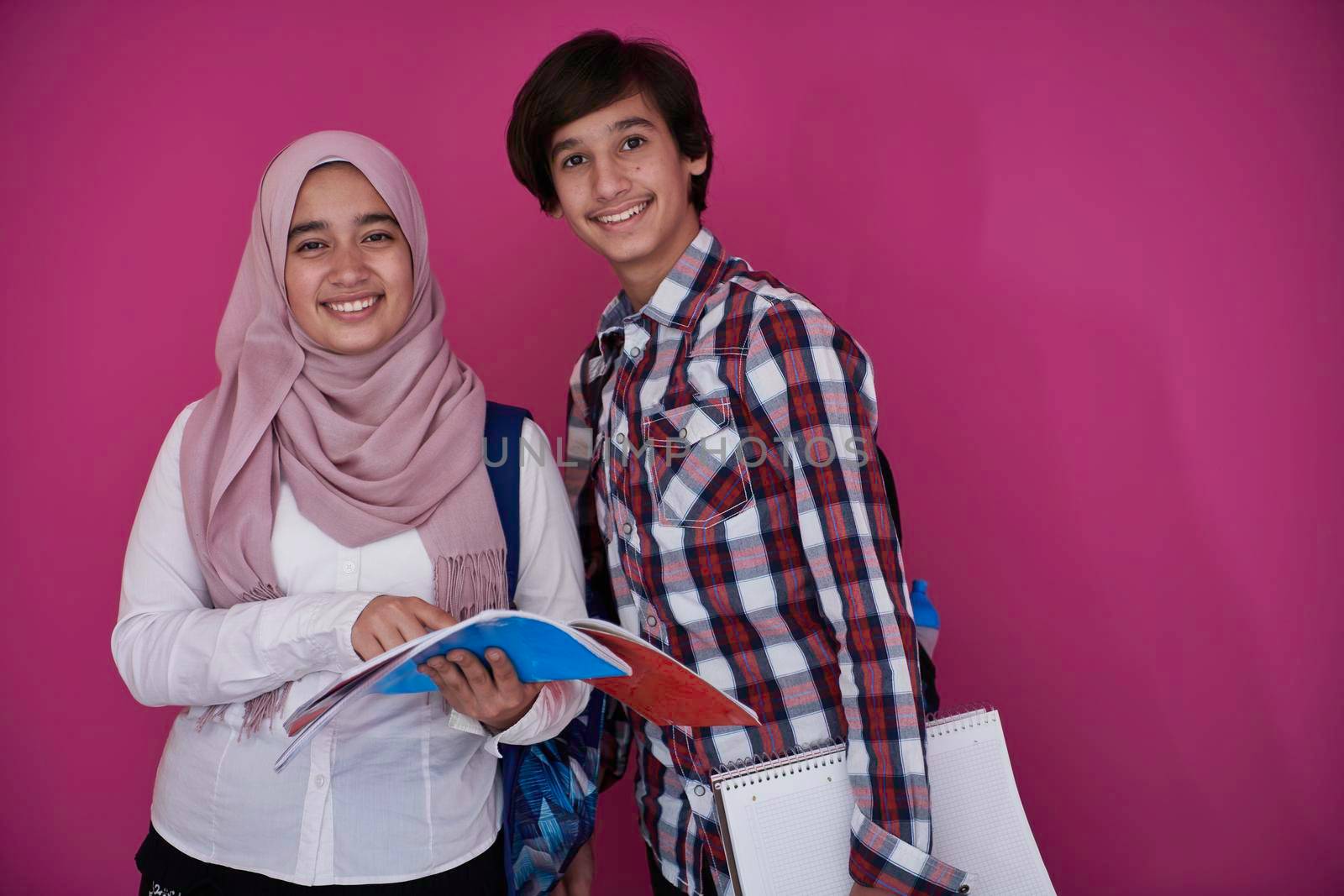 Arabic teenagers group, students team walking forward in future and back to school concept pink background