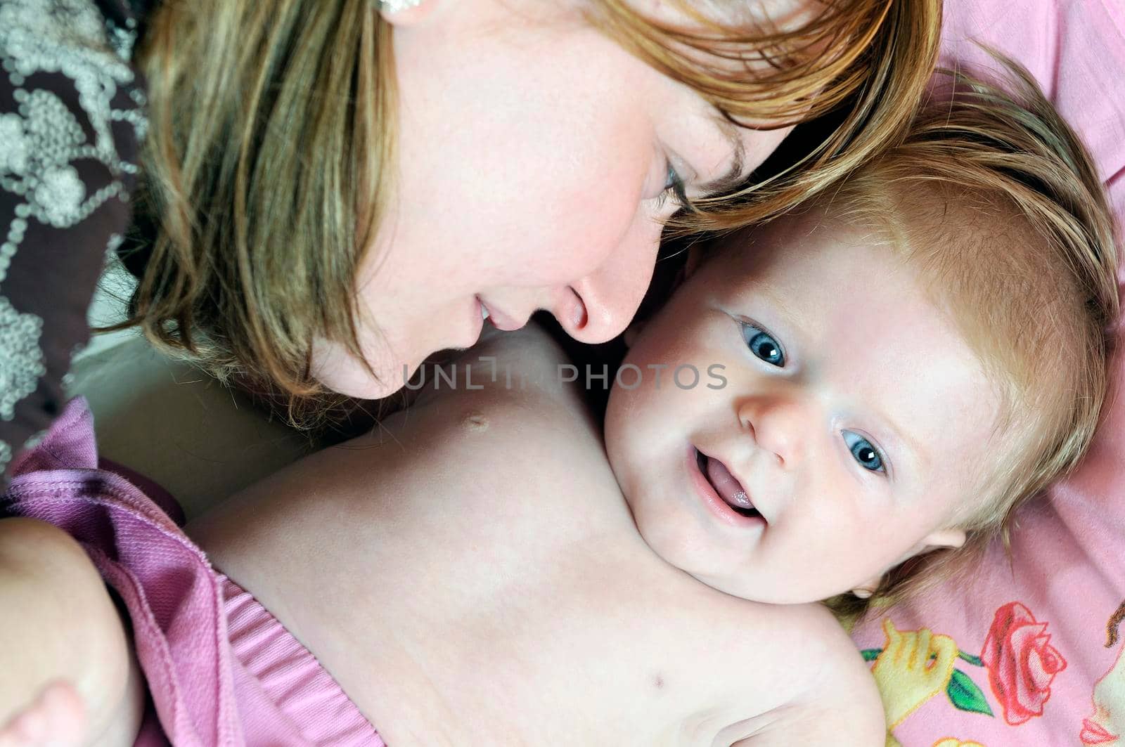 beautiful blonde young mother and cute baby by dotshock