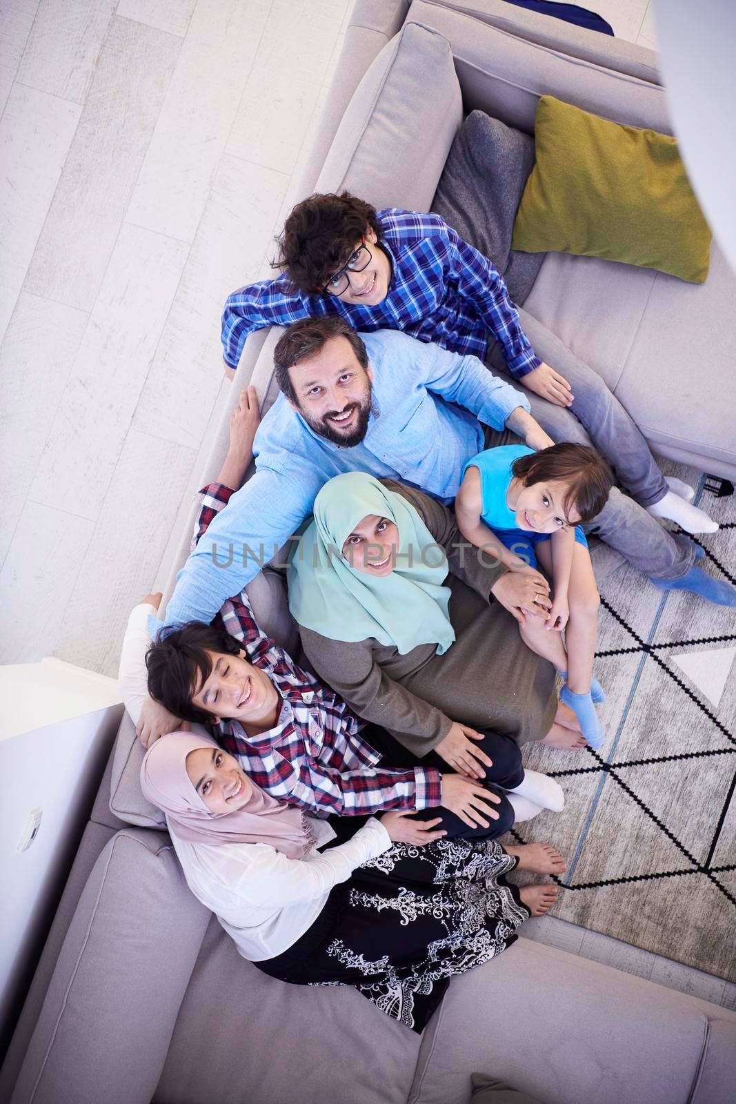 muslim family portrait with arab  teenage kids at modern home interior top view