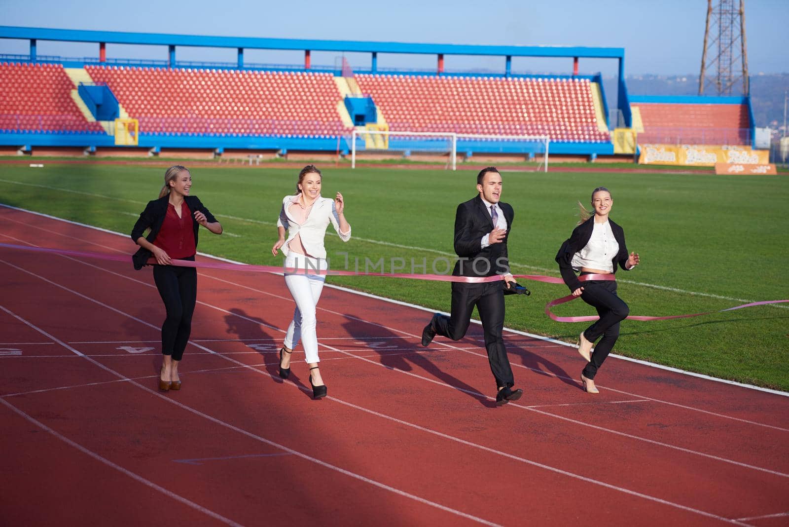 business people running together on  athletics racing track