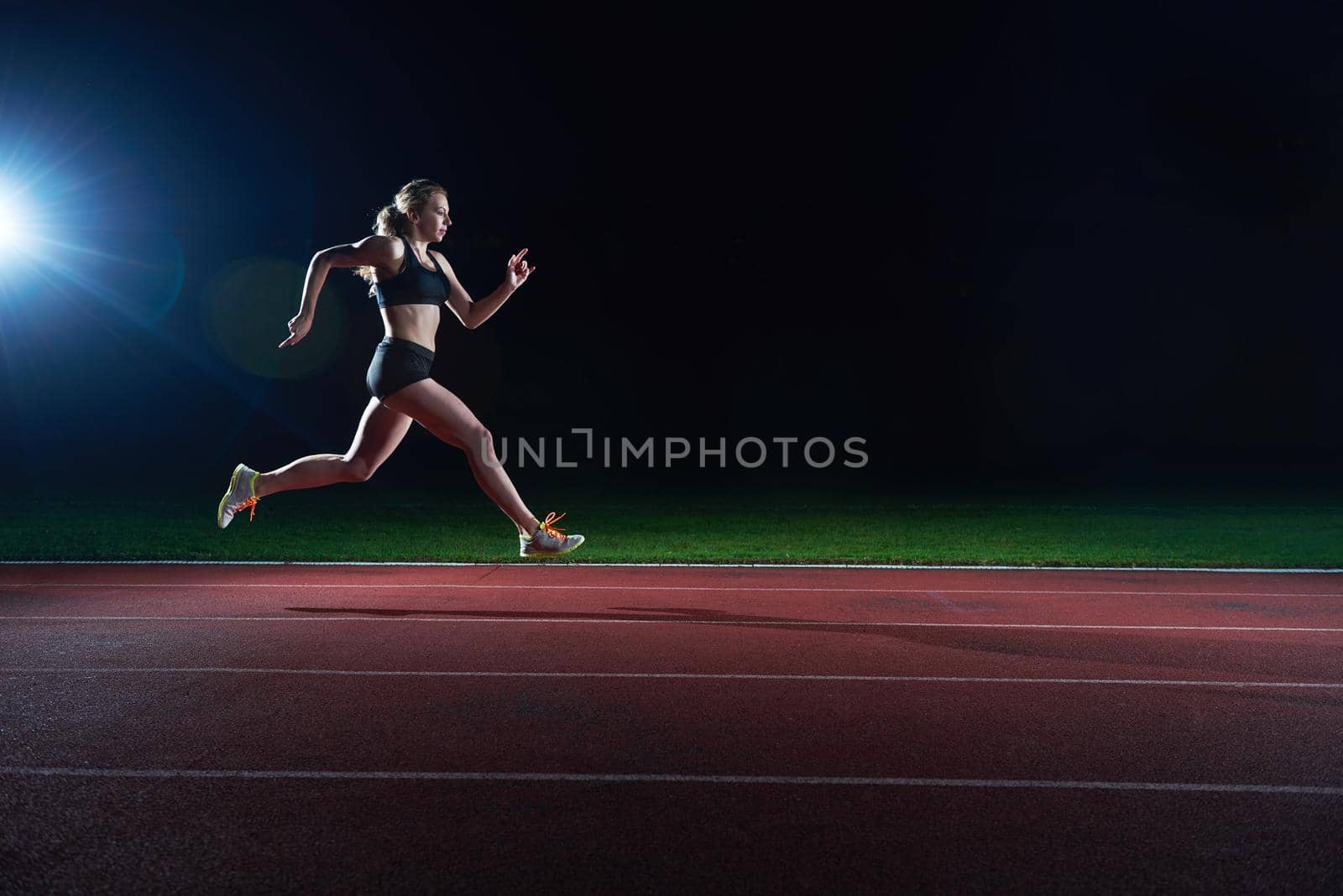 Athletic woman running onrace  track