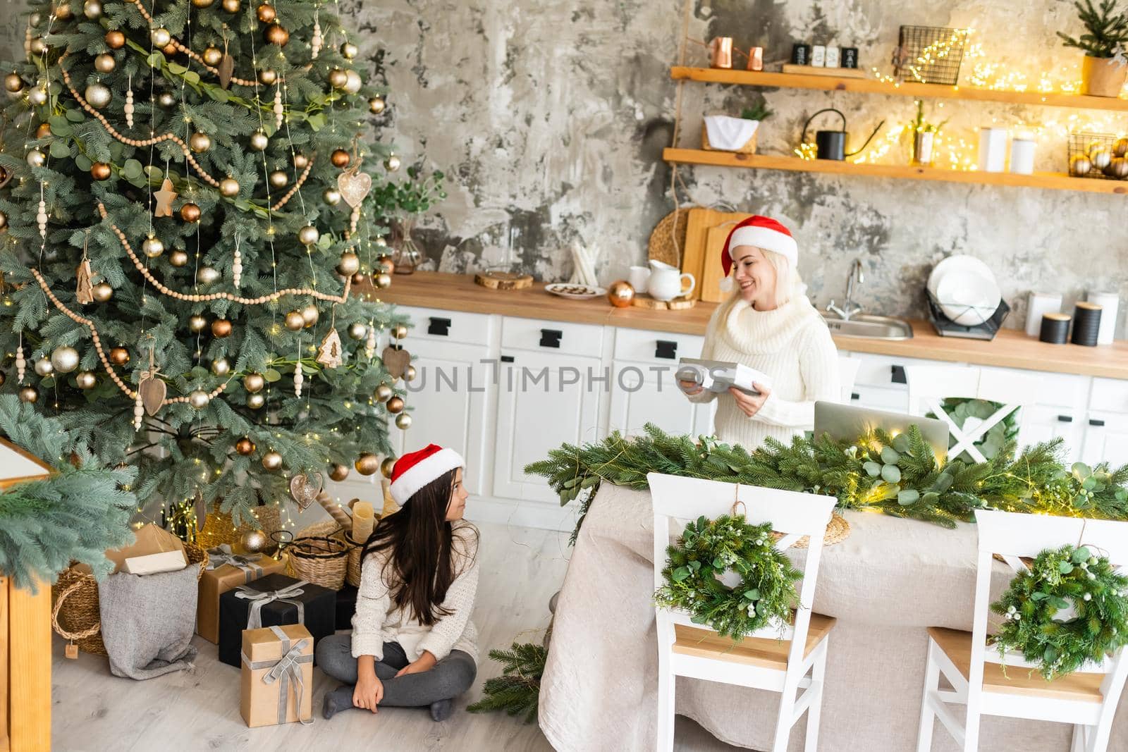 Friendship and love of mom and daughter. Family values. Preparing to celebrate Christmas. Christmas tree decoration. Building a good relationship between mother and daughter