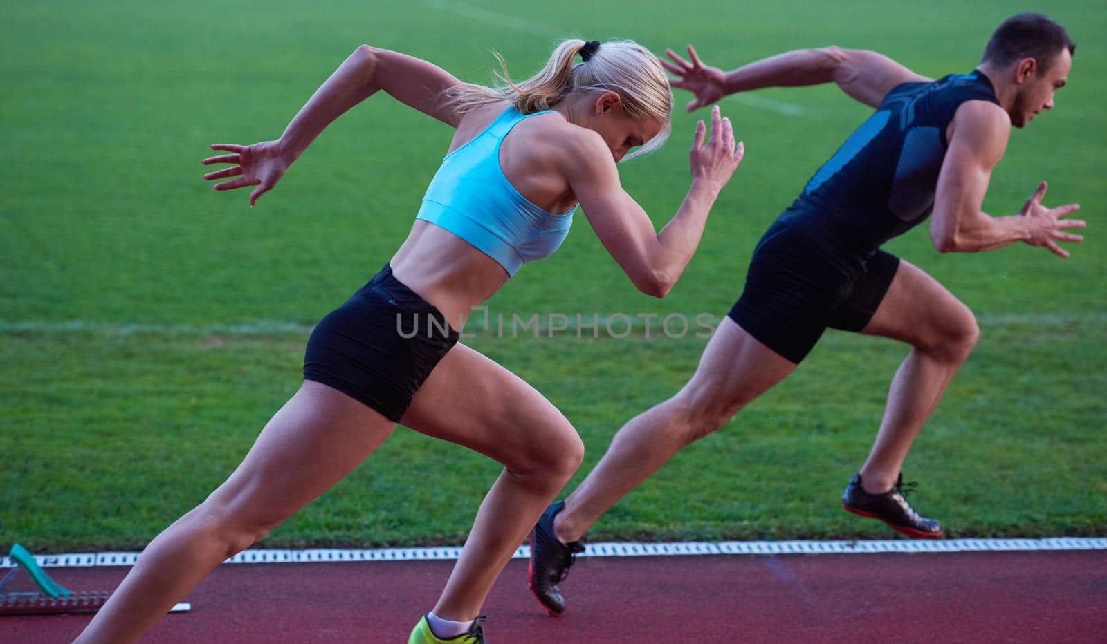 athlete woman group  running on athletics race track on soccer stadium and representing competition and leadership concept in sport