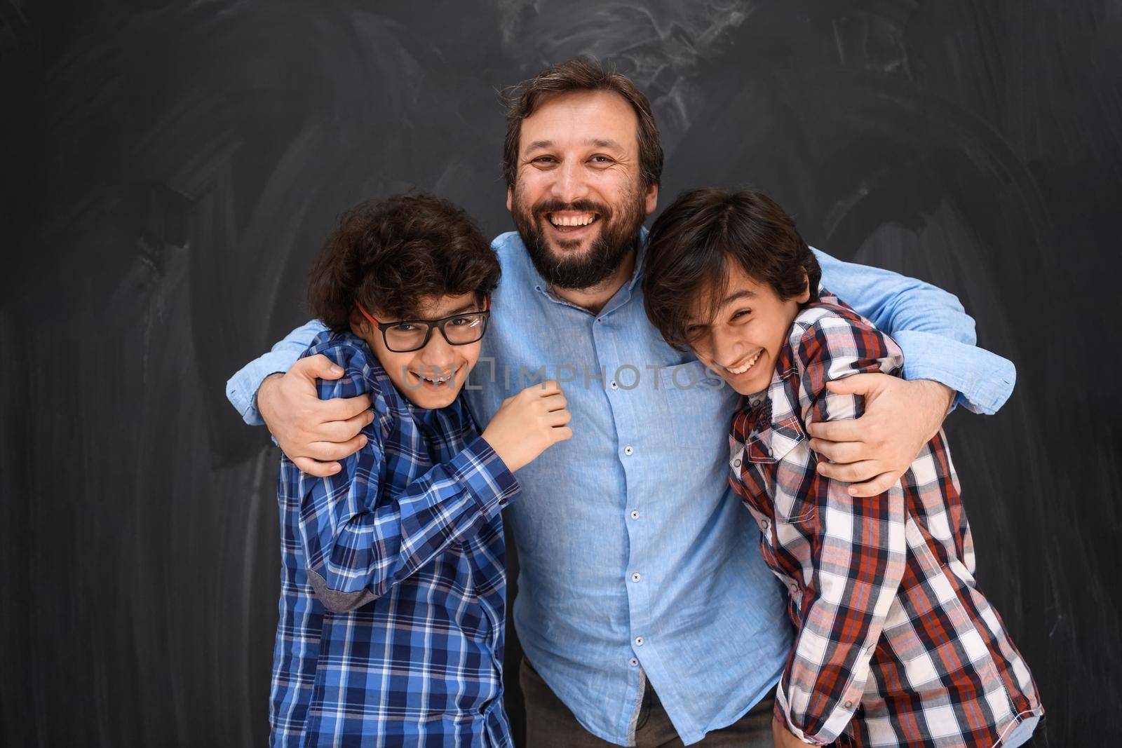 happy father hugging sons unforgetable moments of family joy in mixed race middle eastern arab family by dotshock