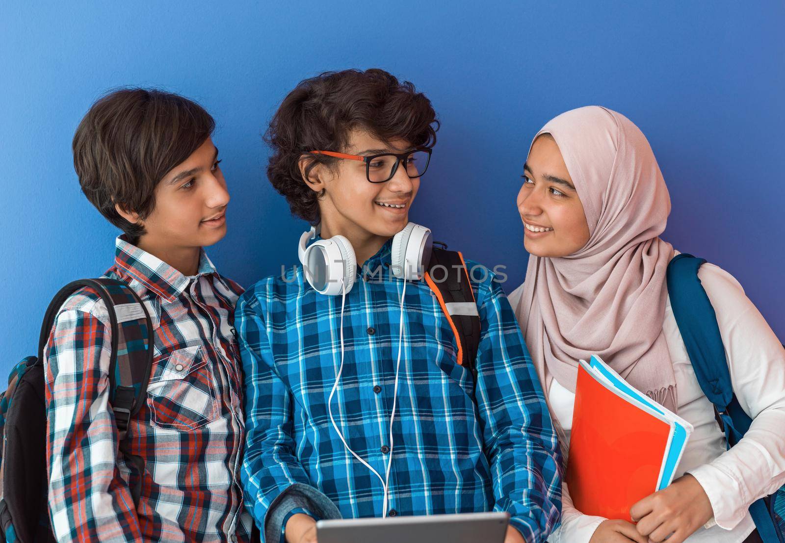 Modern arab teens use smartphone, tablet and latpop to study during online classes due to corona virus pandemic by dotshock