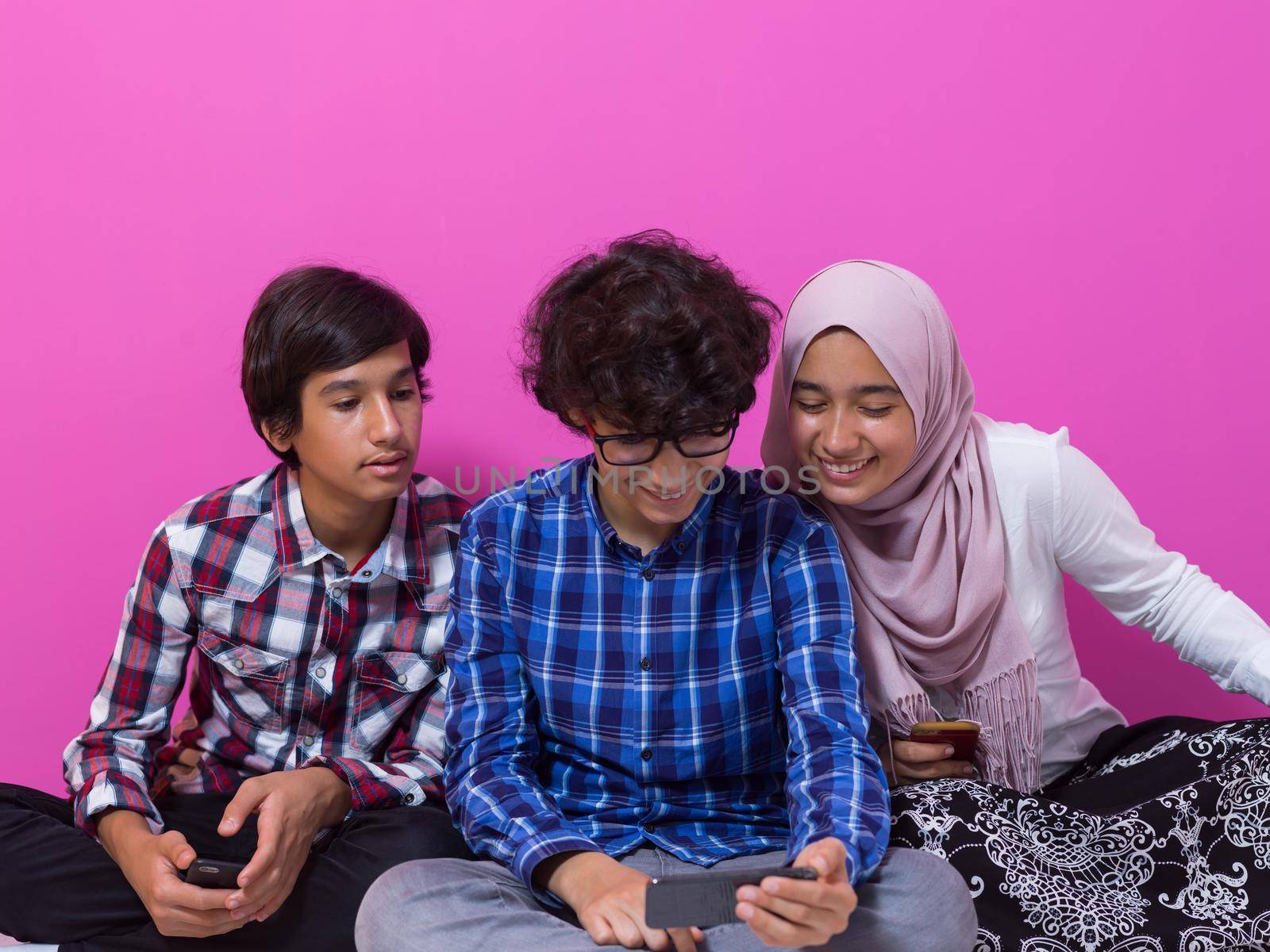 arab teenagers group using smart phones for social media networking and sharing of informations for online education by dotshock