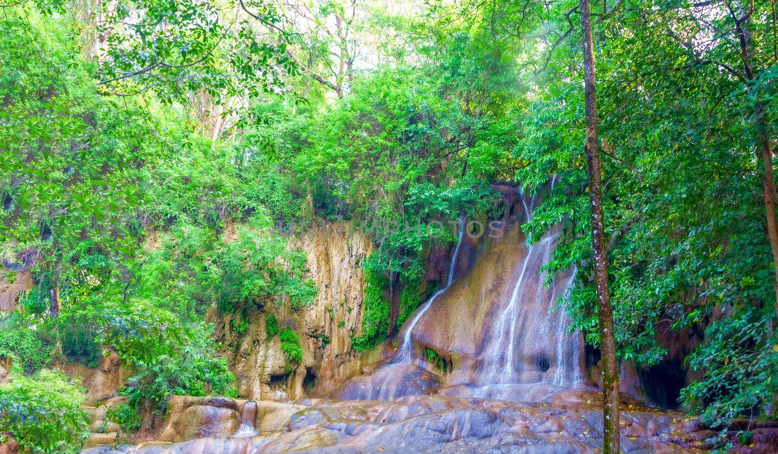 Beautiful waterfall among the thick greenery on the river Kwai, Thailand.