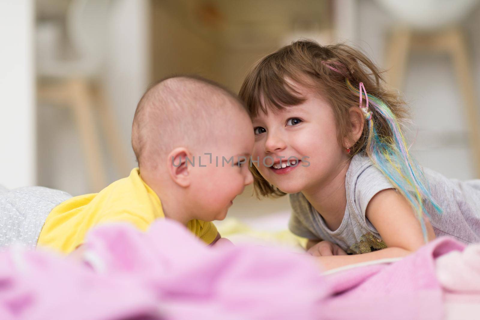 little sister and her baby brother playing at home by dotshock