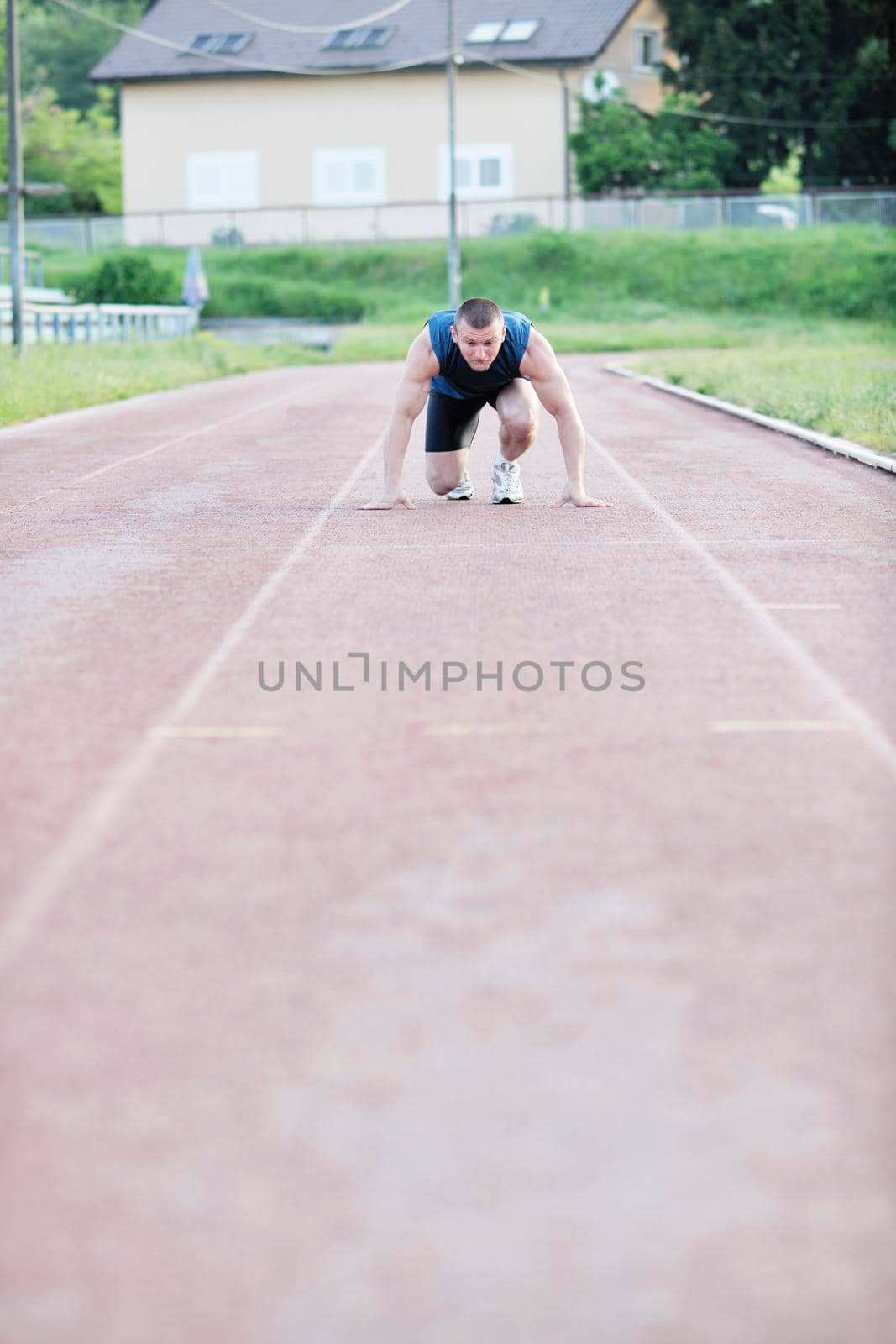 healthy young man at start line ready for run race and win