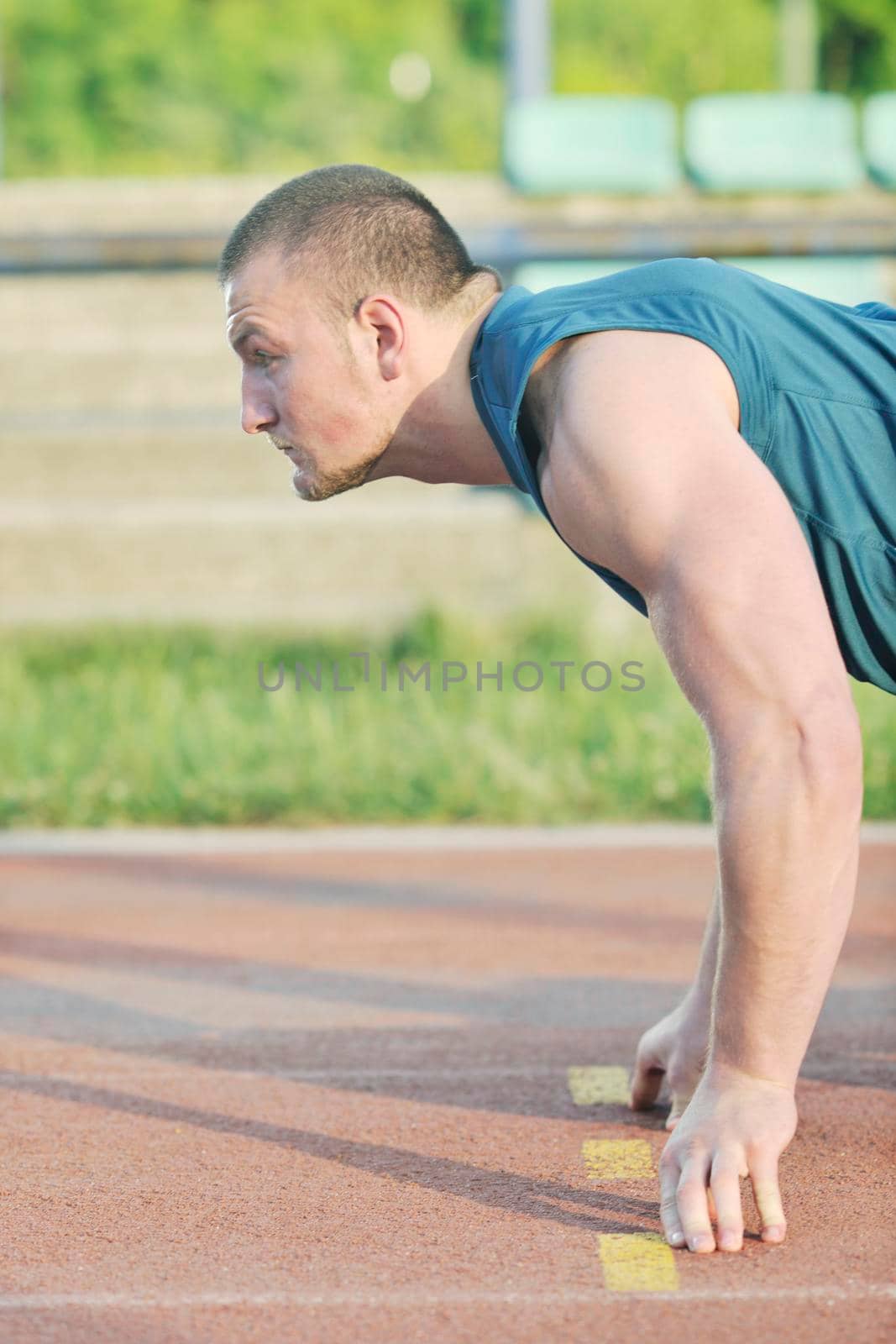 healthy young man at start line ready for run race and win