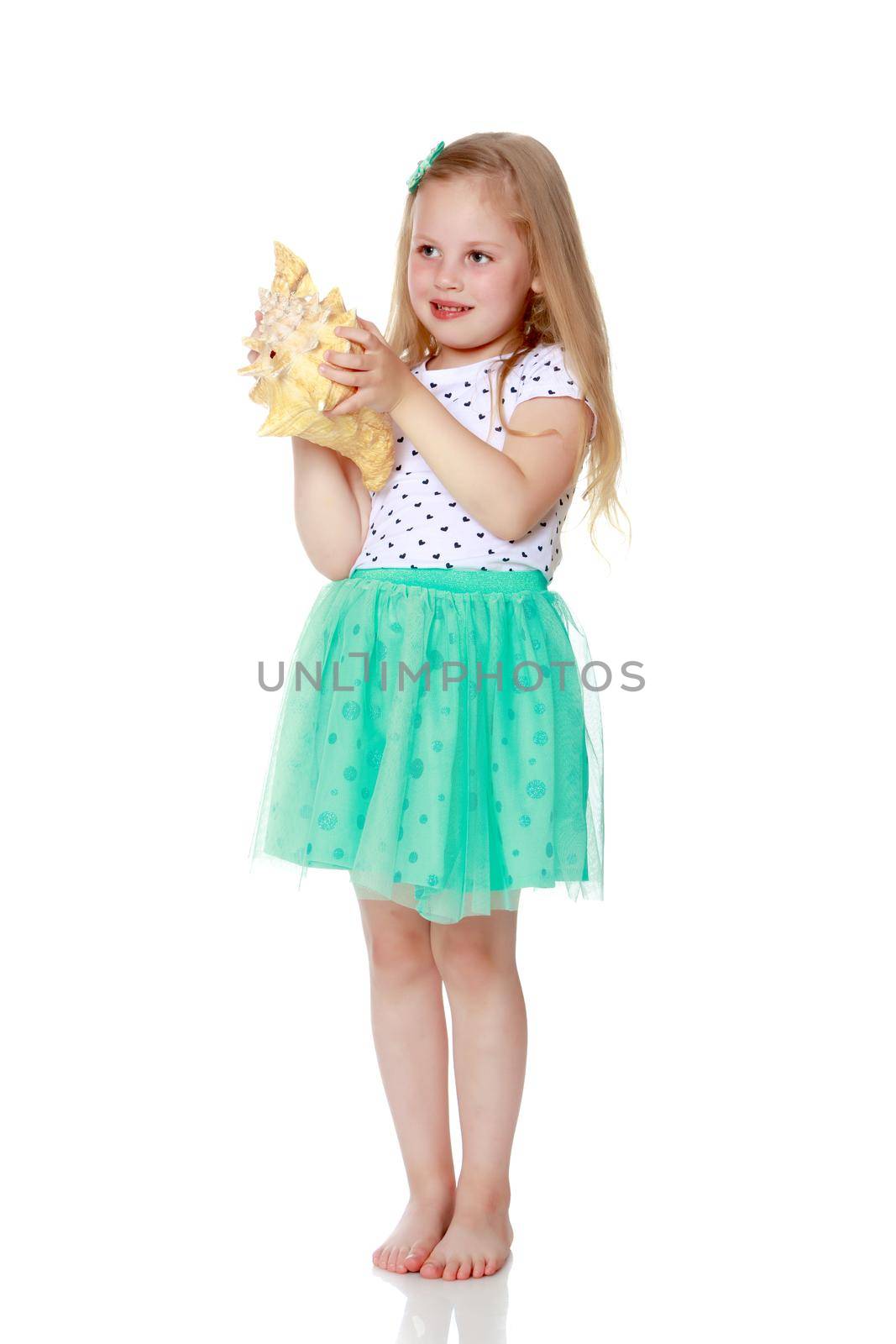 A little girl with a sea shell. The concept of a family vacation at sea, ecology. Isolated on white background.