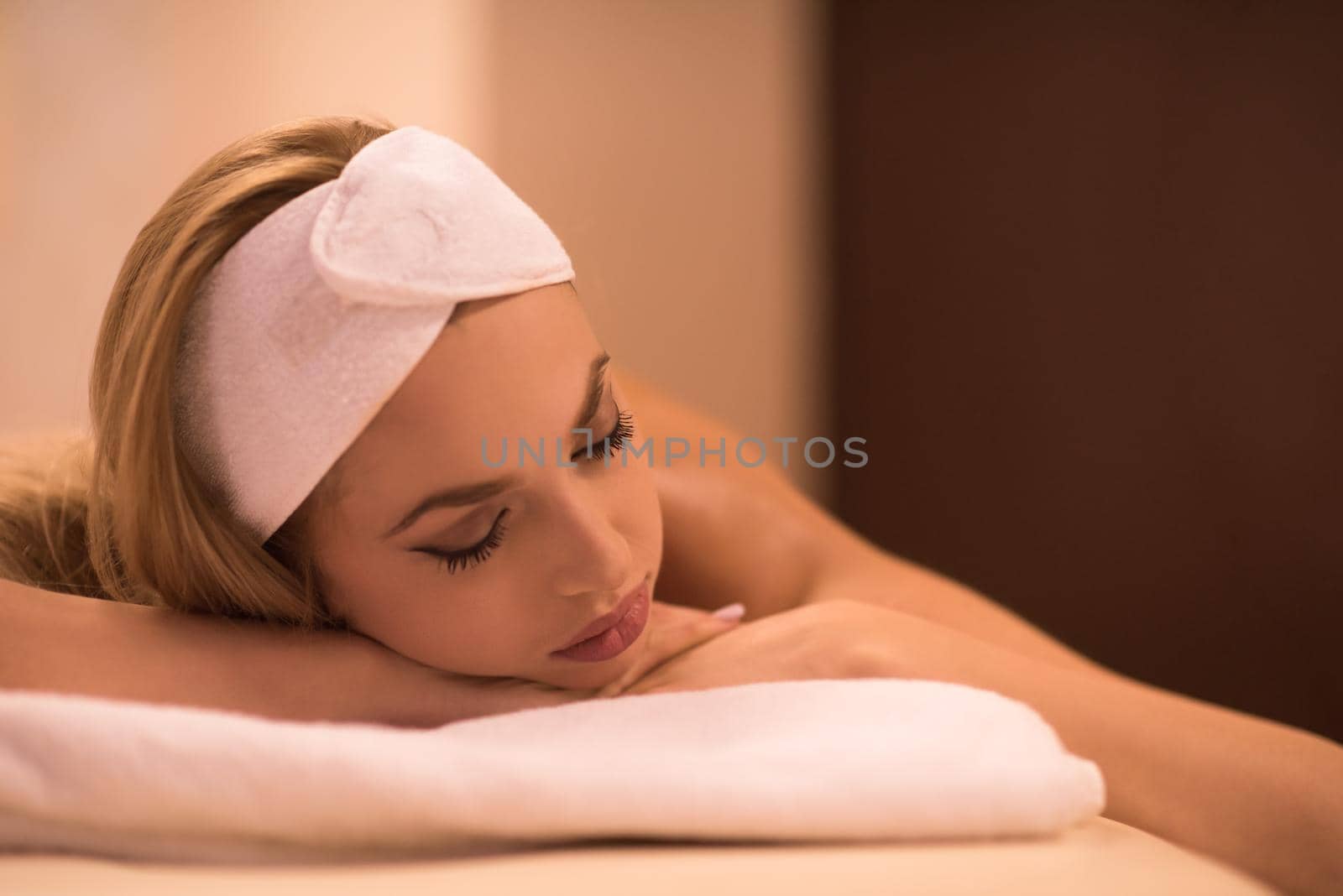 Relaxed young beautiful  woman laying on massage table