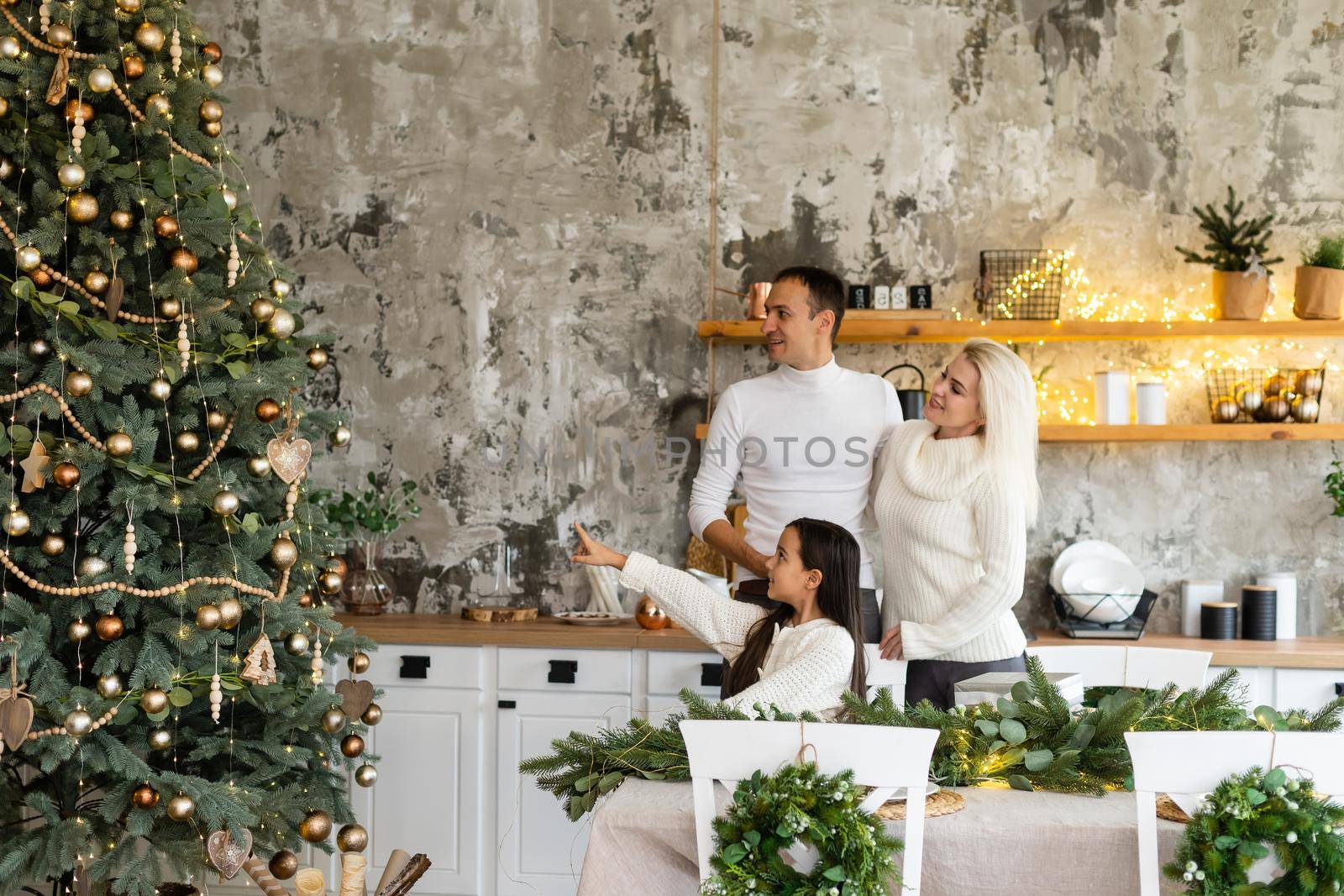 family, christmas, x-mas, winter, happiness and people concept - smiling family Preparing to celebrate Christmas. by Andelov13