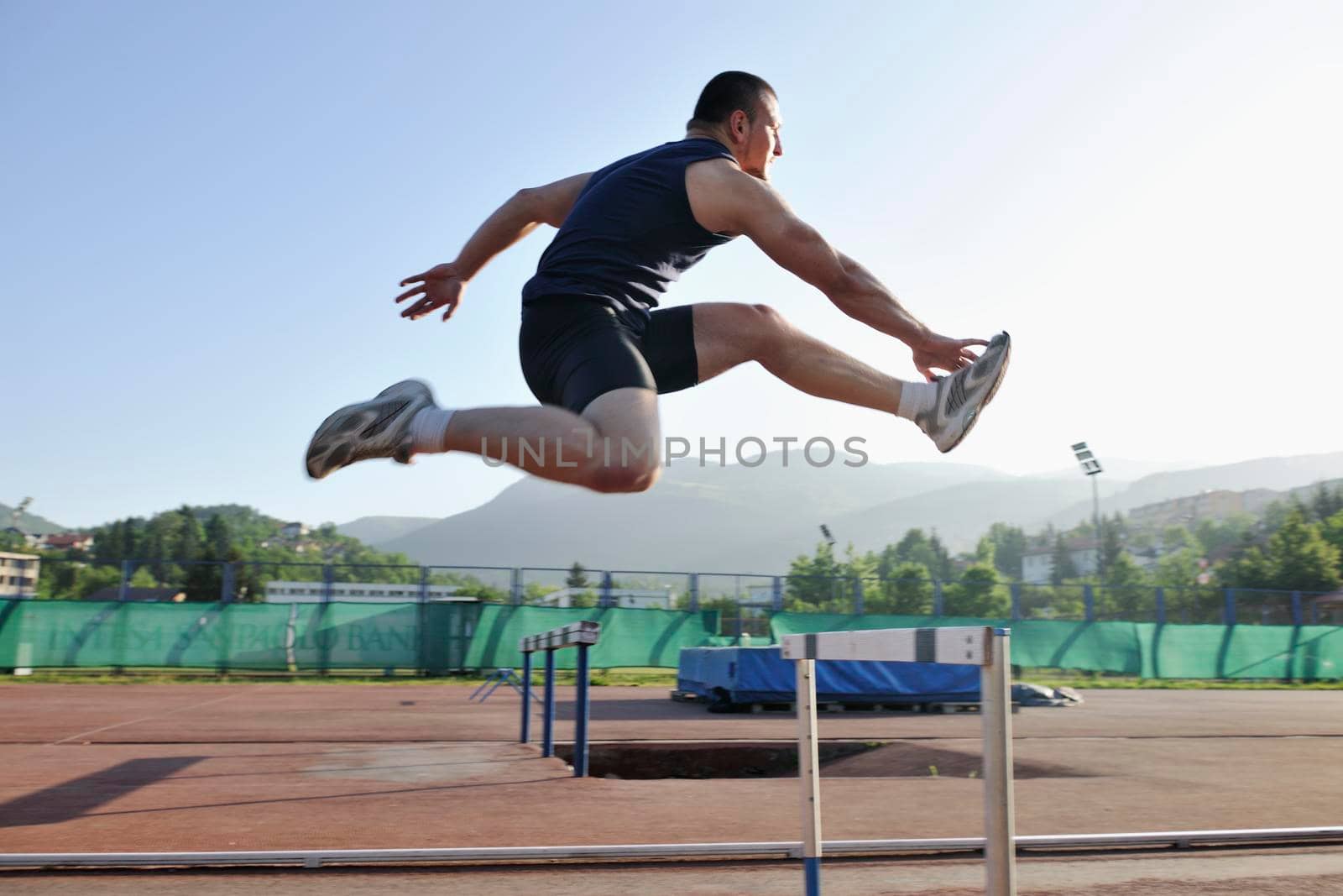 young healthy man run on athletic race sport track and representing concept of sort and speed