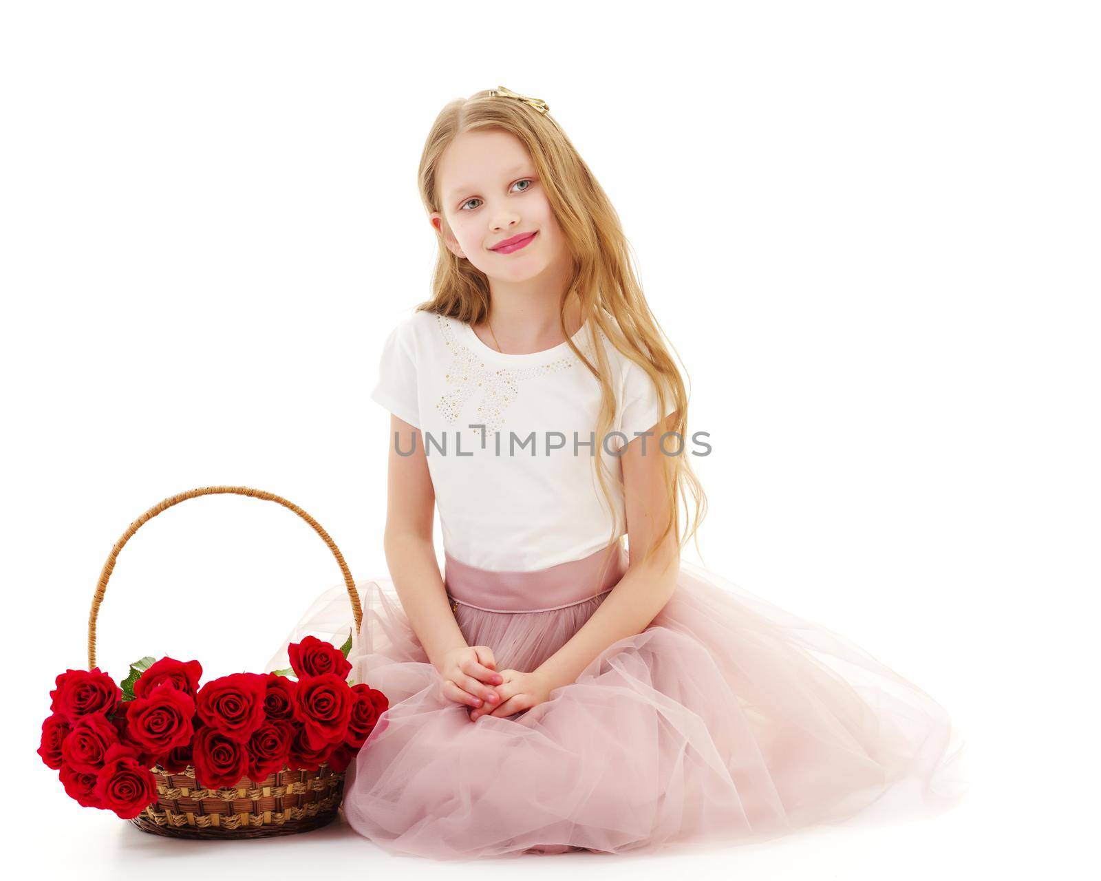 Charming little girl with a basket of flowers. Concept of holiday, summer mood. Isolated on white background.