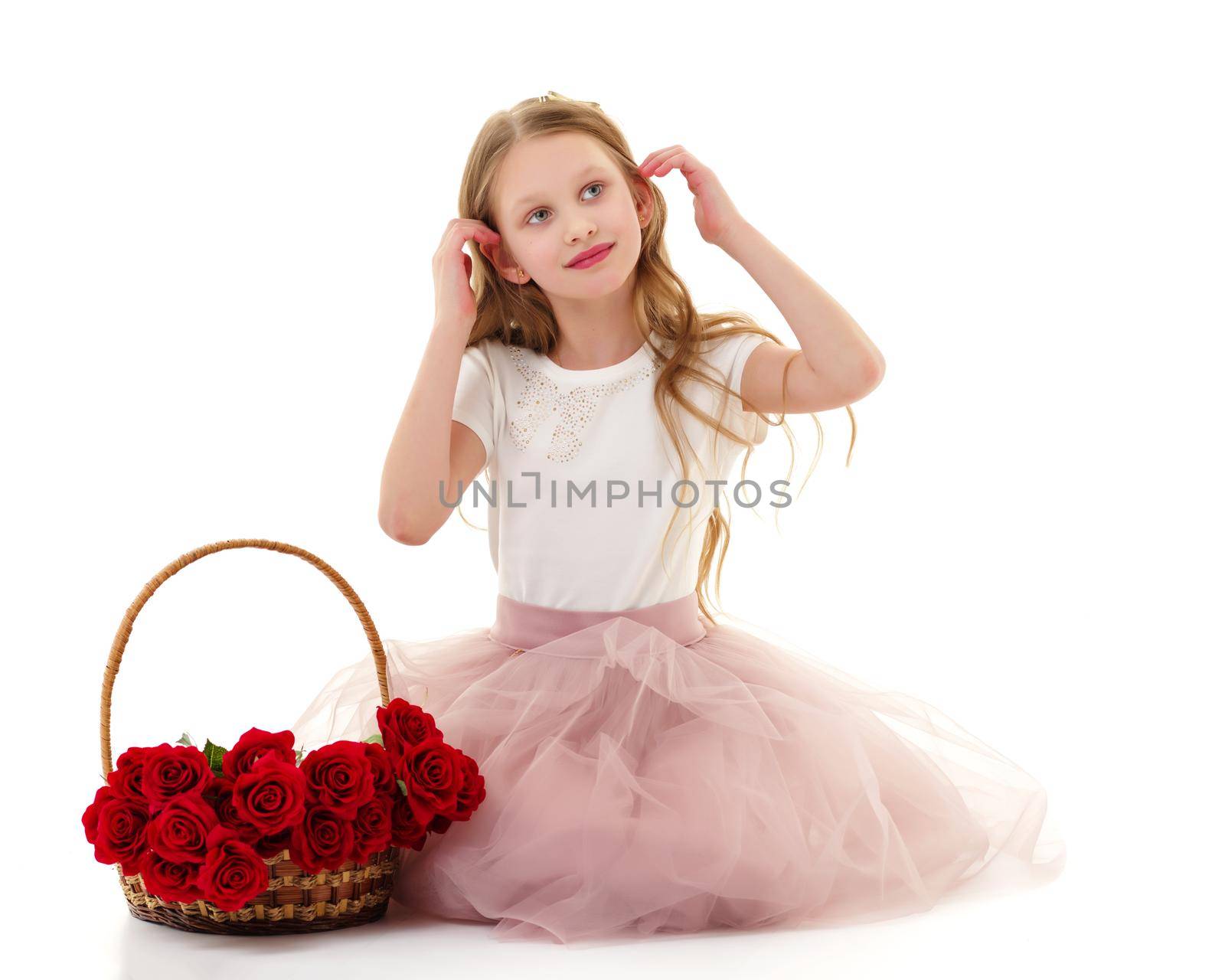 Charming little girl with a basket of flowers. Concept of holiday, summer mood. Isolated on white background.