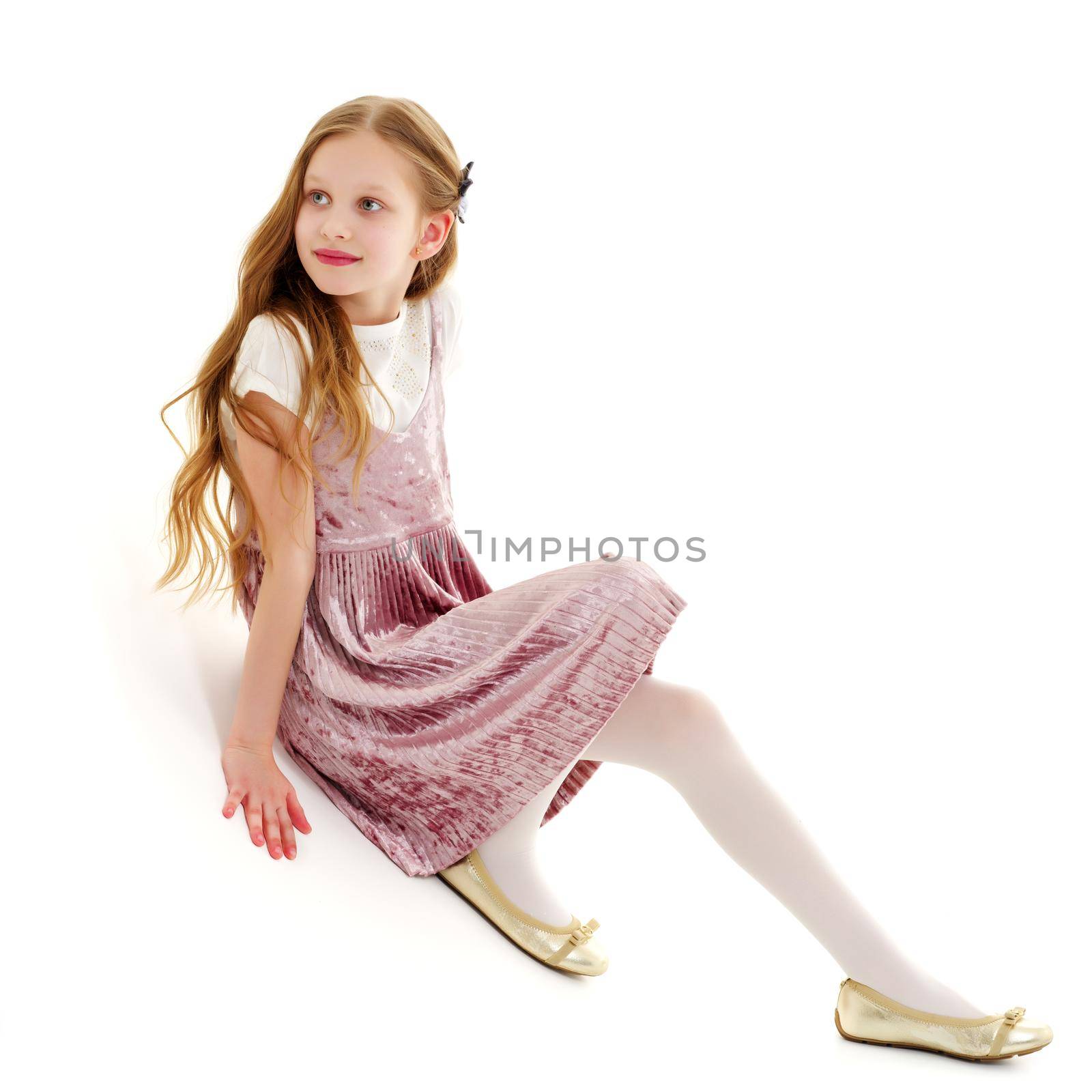 A little girl is photographed in the studio on a cyclorame. by kolesnikov_studio