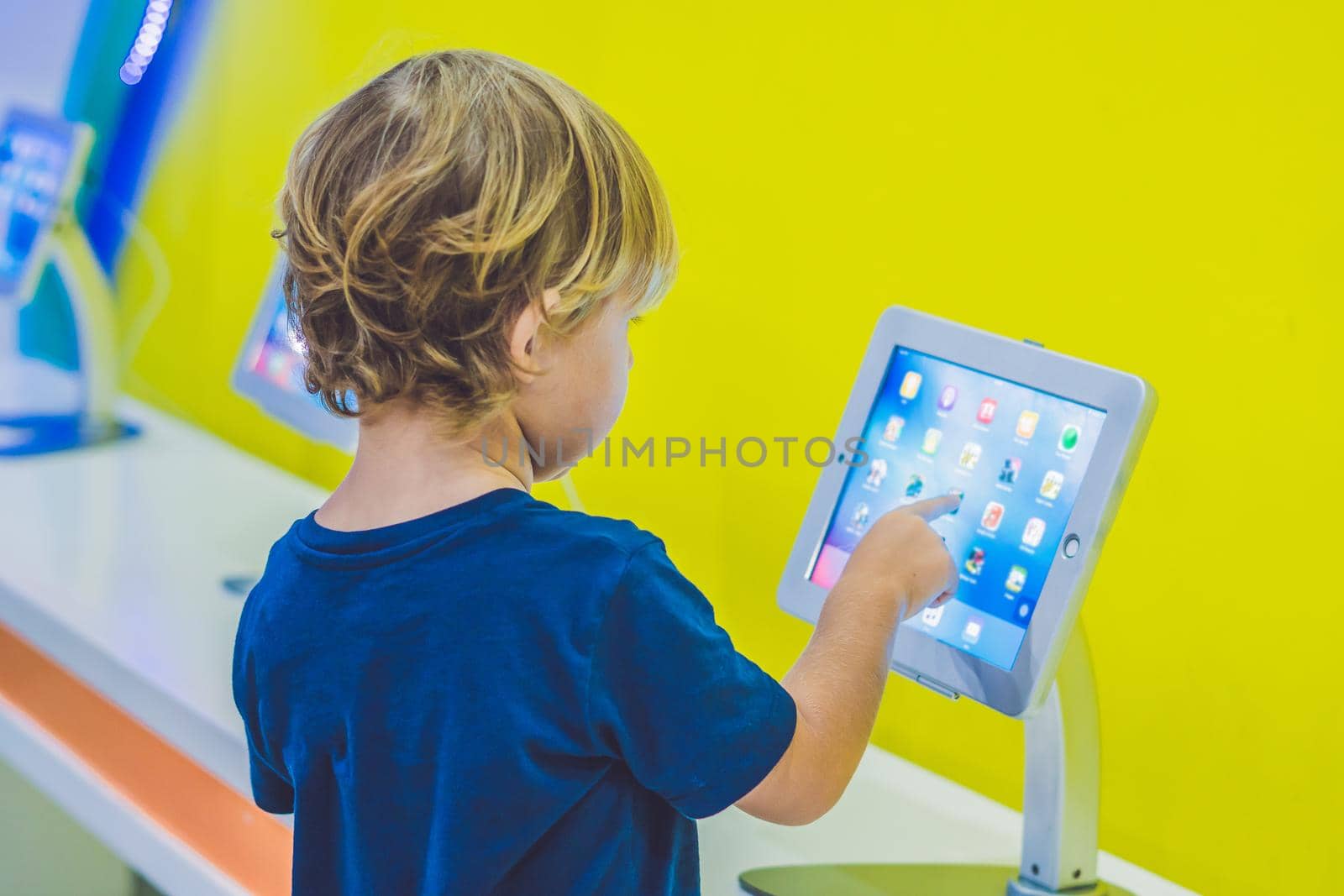 Boy playing with digital tablet. Children and technology concept.