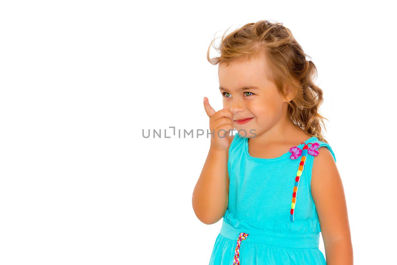 The little girl points with her finger. The concept of play and happy childhood. Isolated on white background.