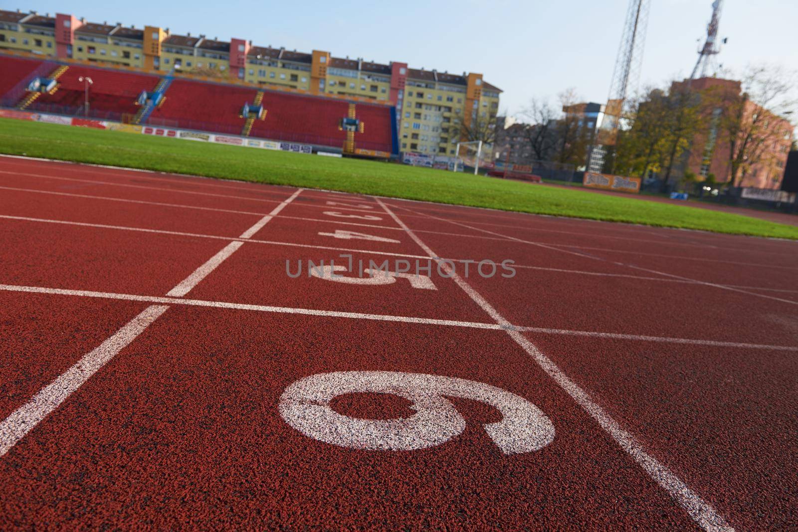 Red athletic track treadmill at the stadium with the numbering.