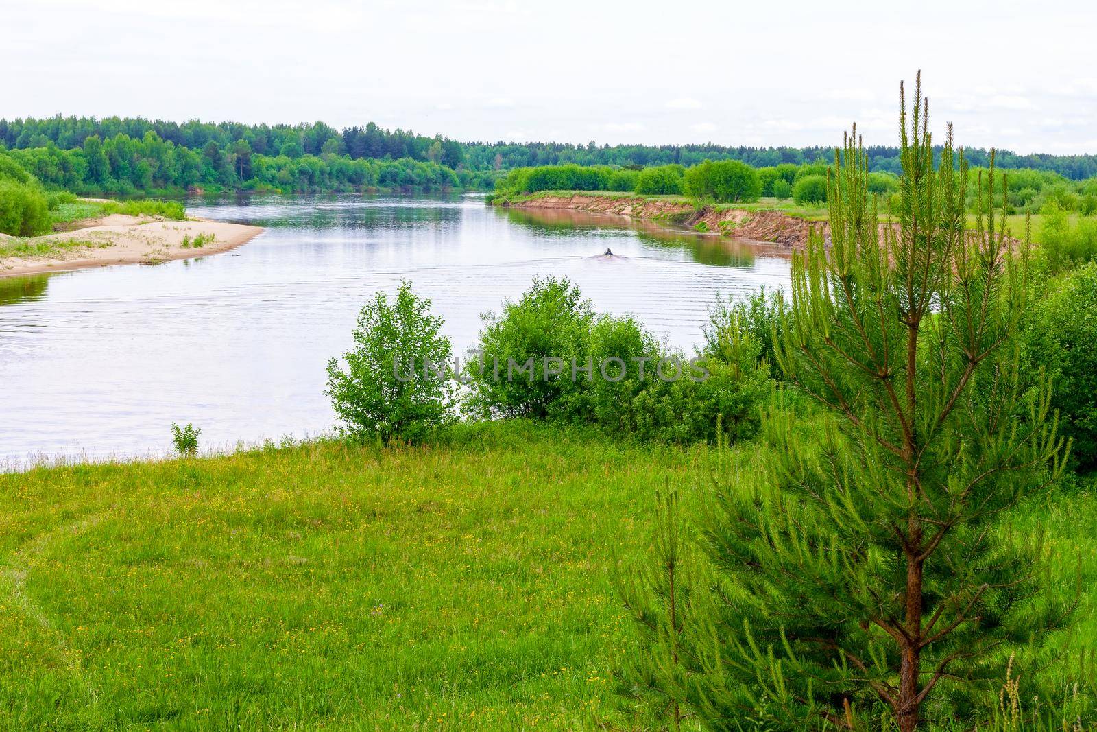 View of the traveler from the shore to the river in Vetluga. Kostroma region. Russia. The concept of tourism, Summer holidays with the whole family.