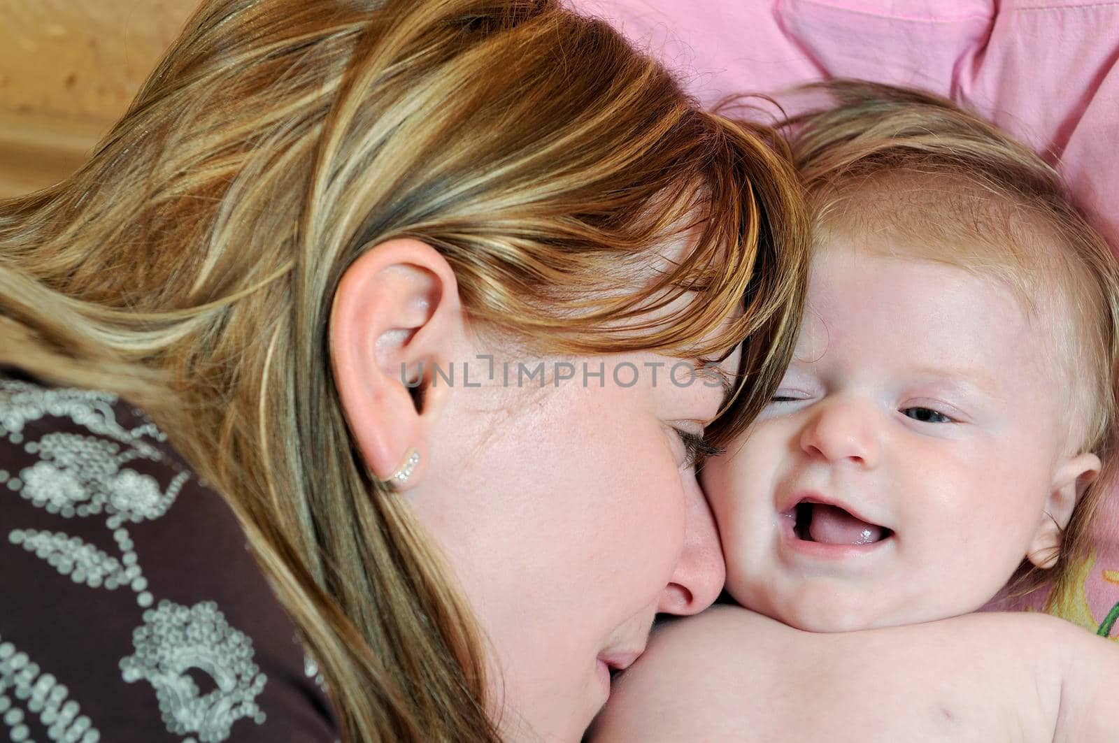 beautiful blonde young mother and cute baby by dotshock