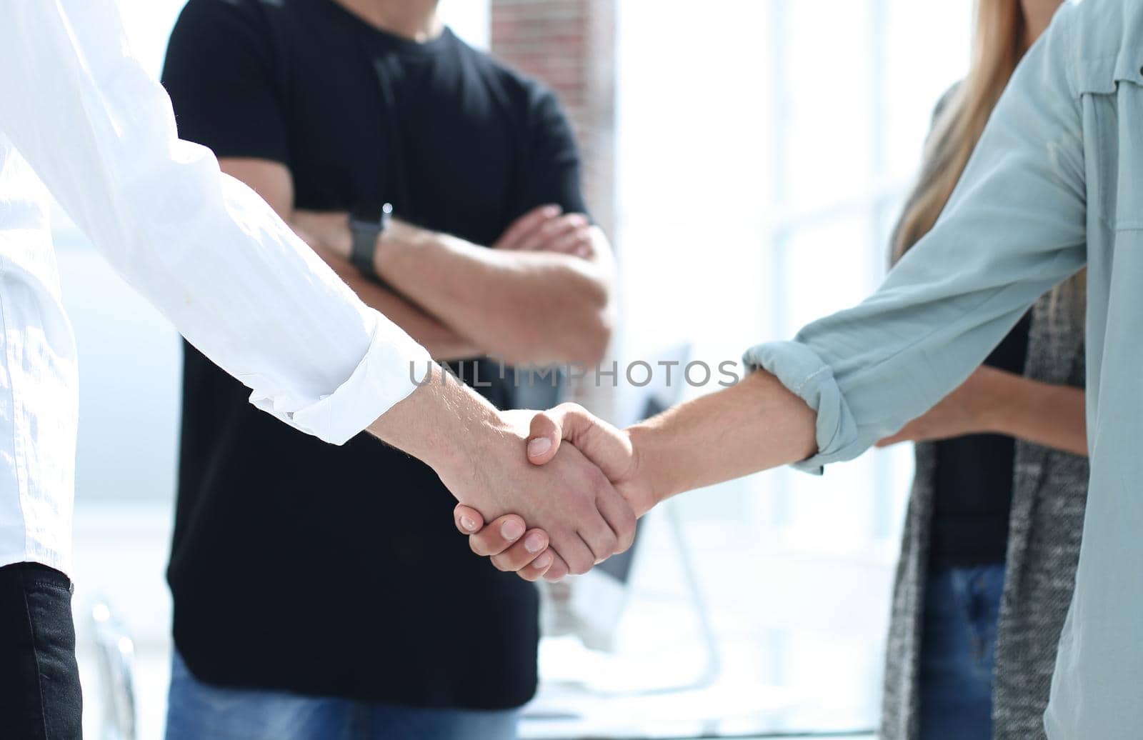 Business people shaking hands in the office after successful meeting.