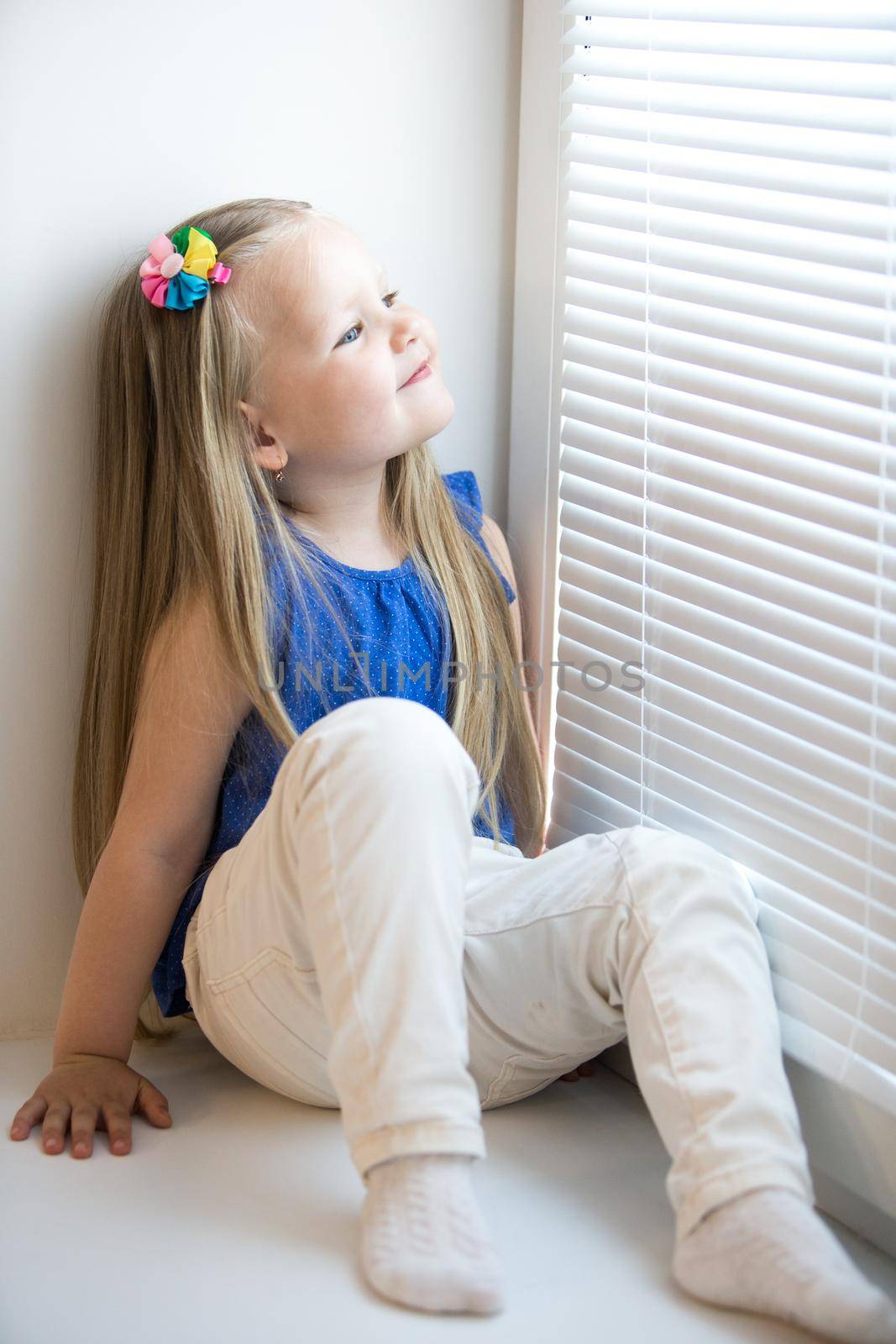 Girl sitting on the windowsill by kolesnikov_studio