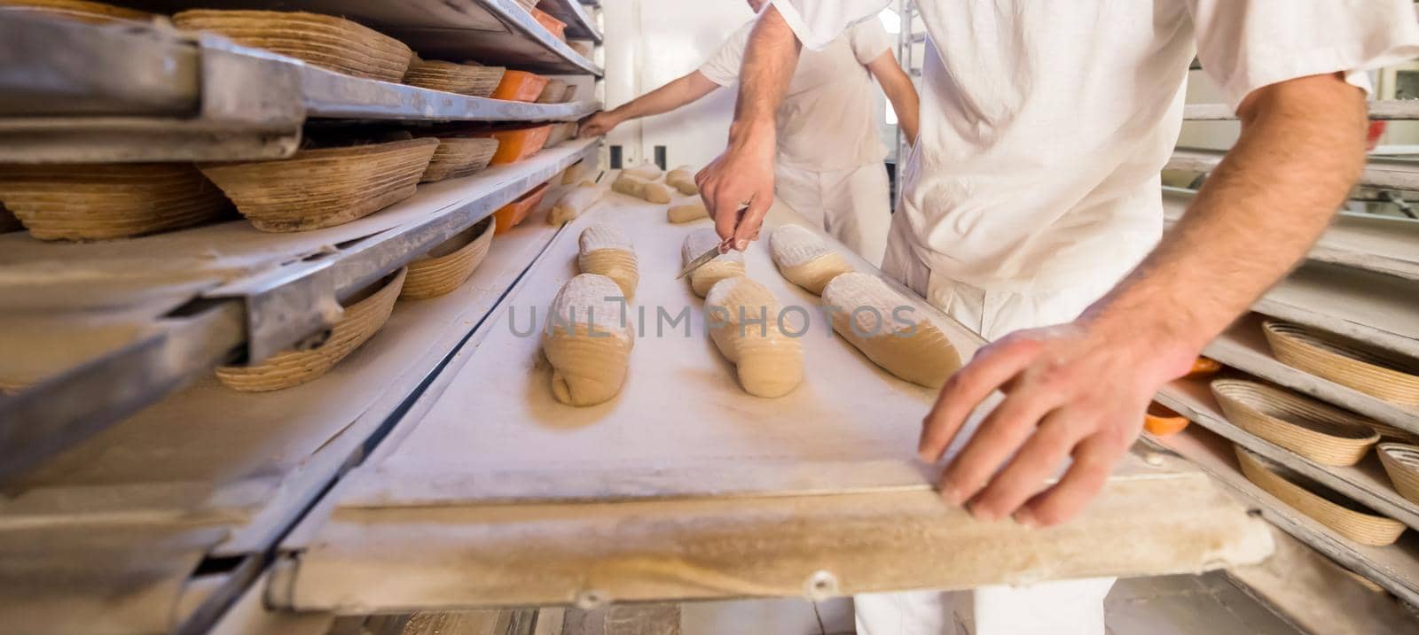 bakers preparing the dough for products In a traditional bakery