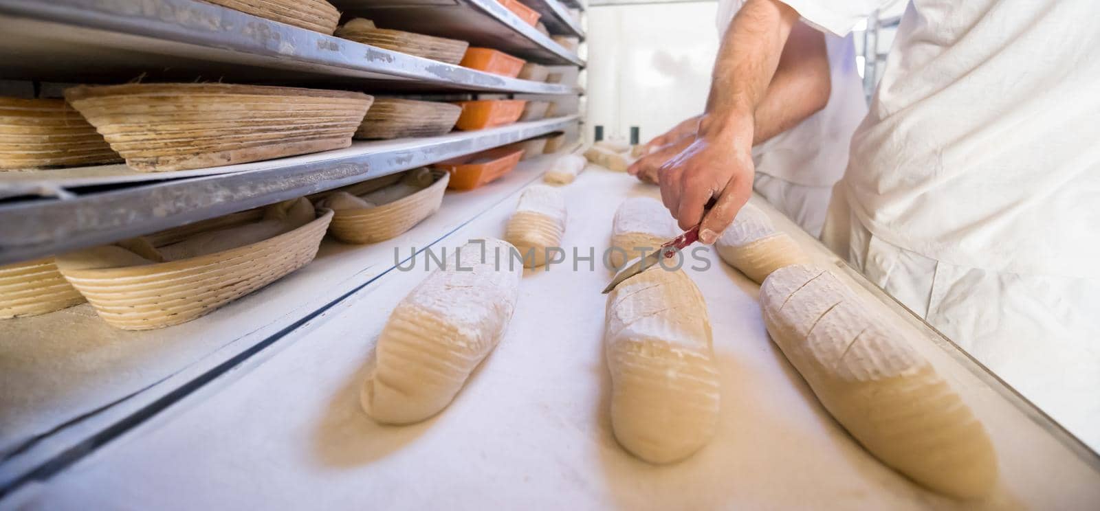 bakers preparing the dough for products In a traditional bakery