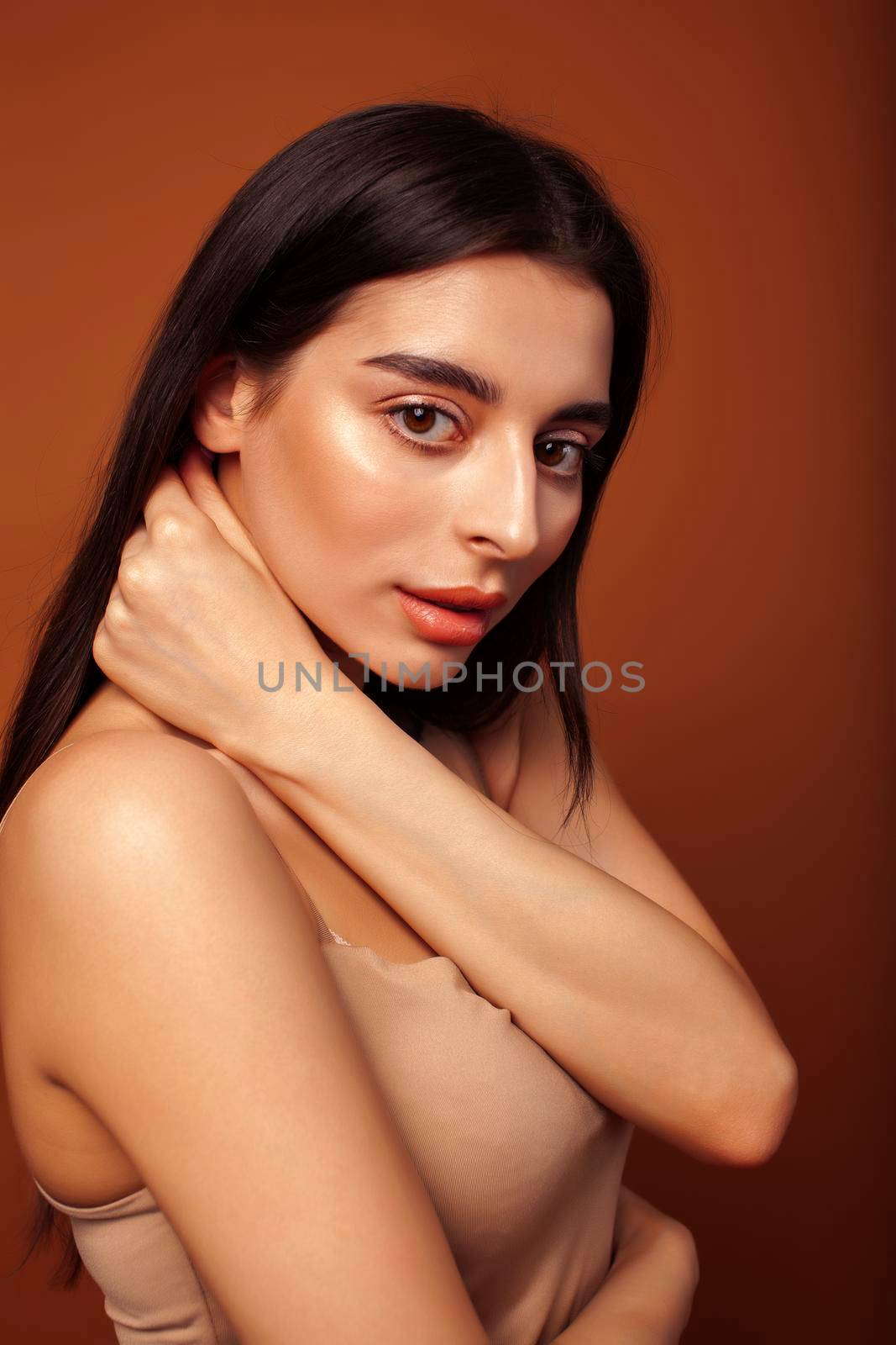 cute happy young indian woman in studio closeup smiling on brown background, fashion beauty lifestyle people concept close up