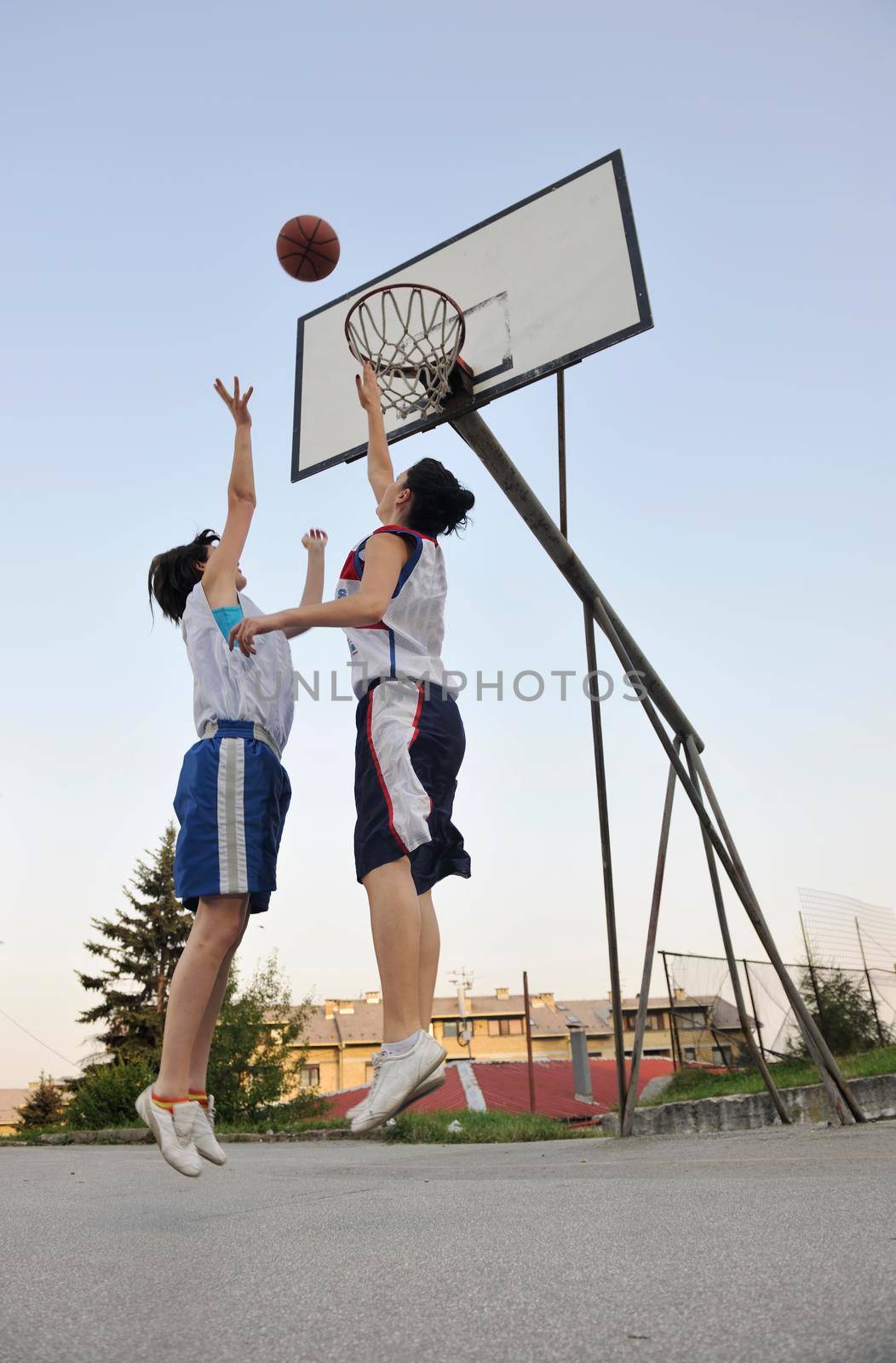 woman basketball player have treining and exercise at basketball court at city on street